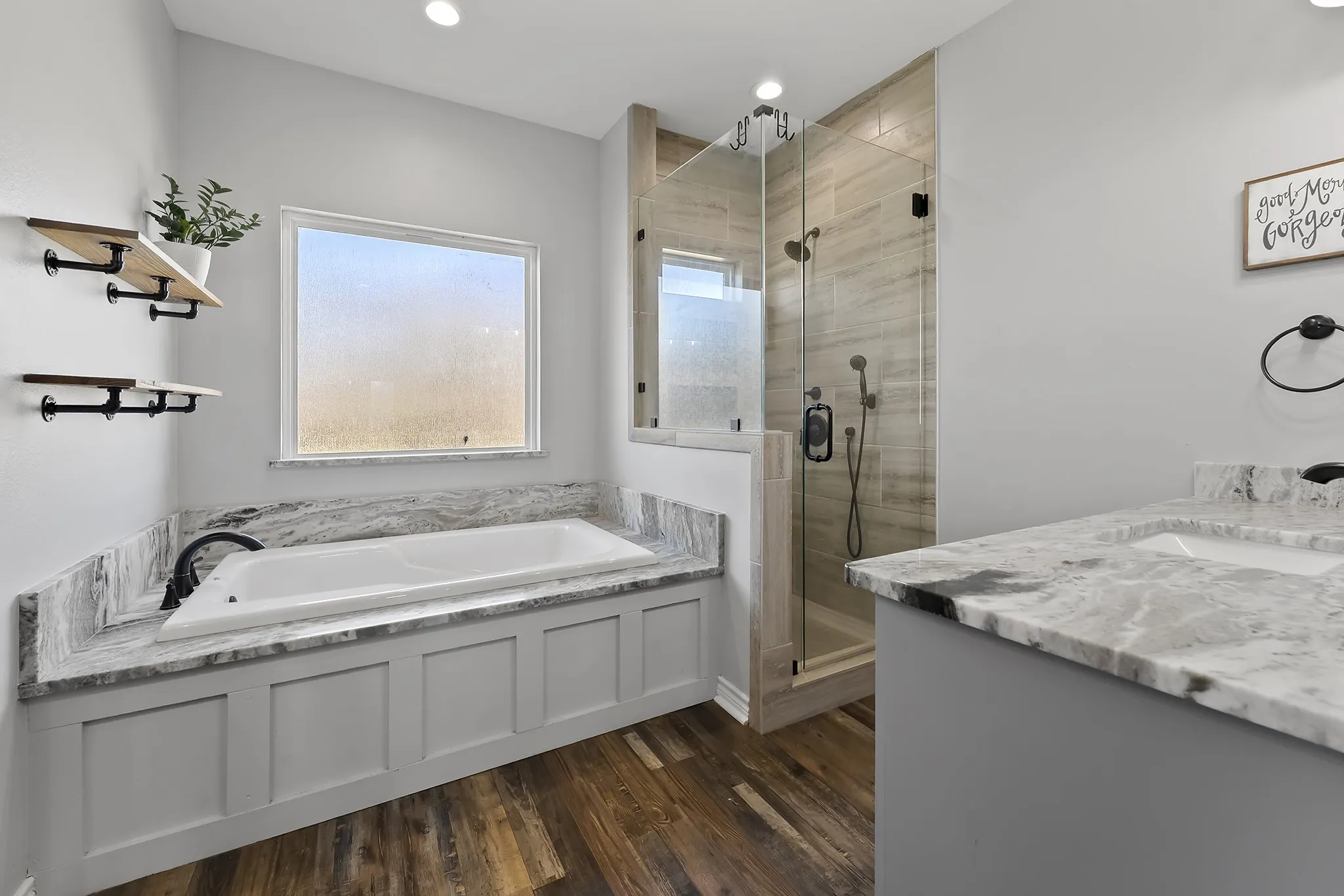Full bathroom featuring vanity, a stall shower, a garden tub, dark wood-type flooring, and recessed lighting