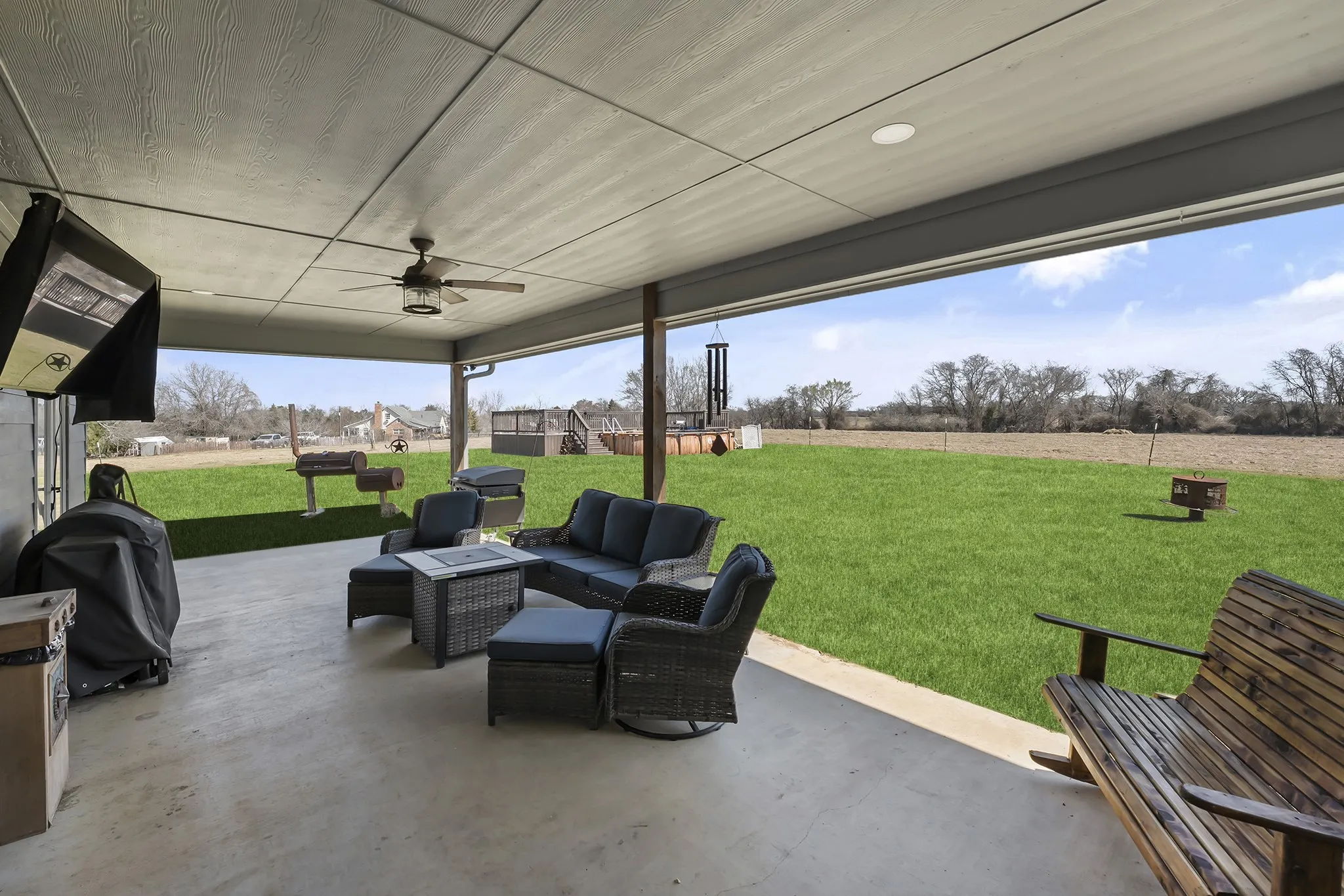 View of patio with an outdoor living space with a fire pit, ceiling fan, and grilling area