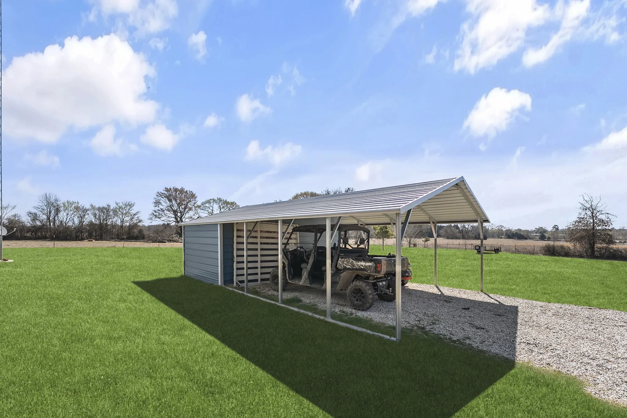 View of green lawn with a rural view and a carport