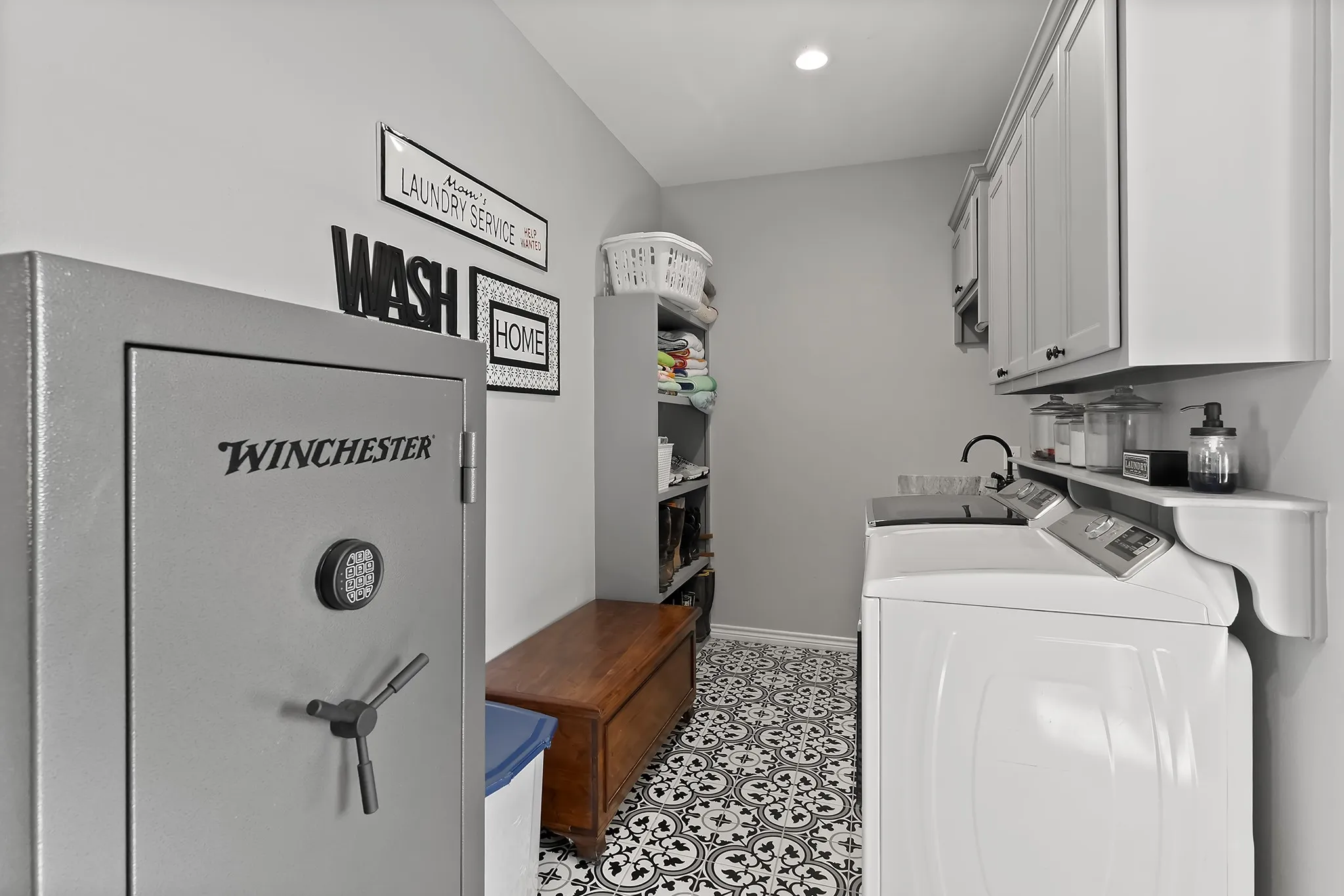 Laundry room with cabinet space, separate washer and dryer, and recessed lighting