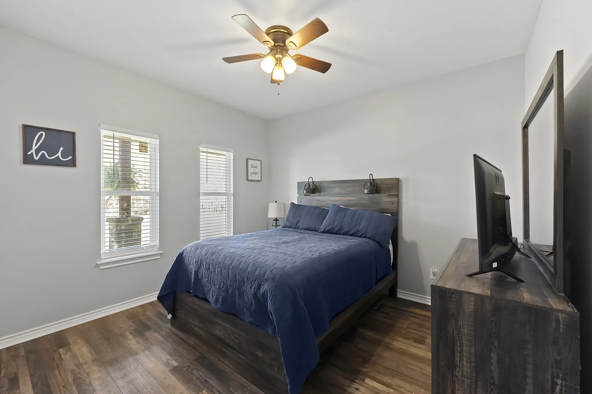 Bedroom with dark wood finished floors and a ceiling fan