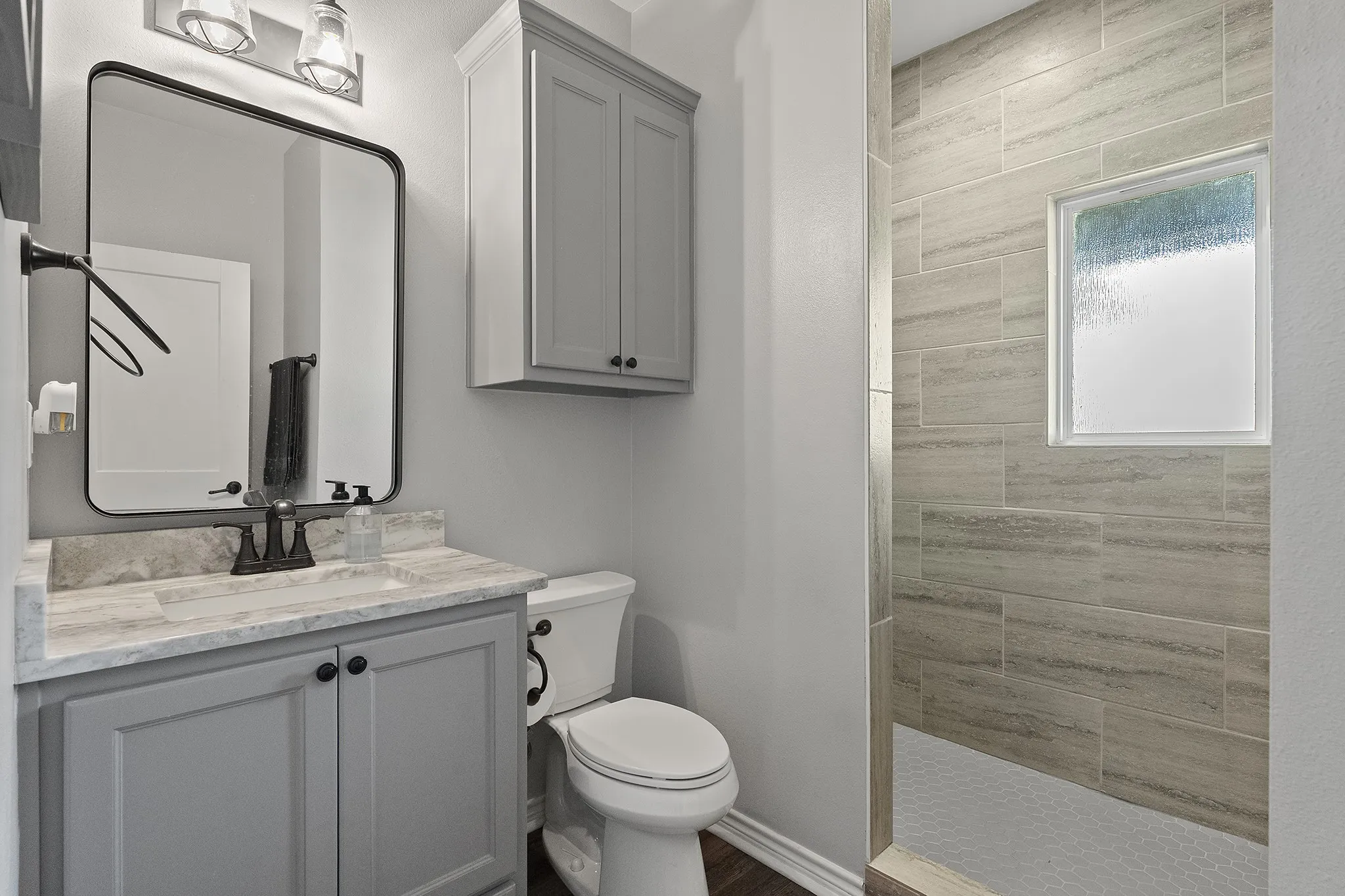 Full bathroom with walk in shower and vanity