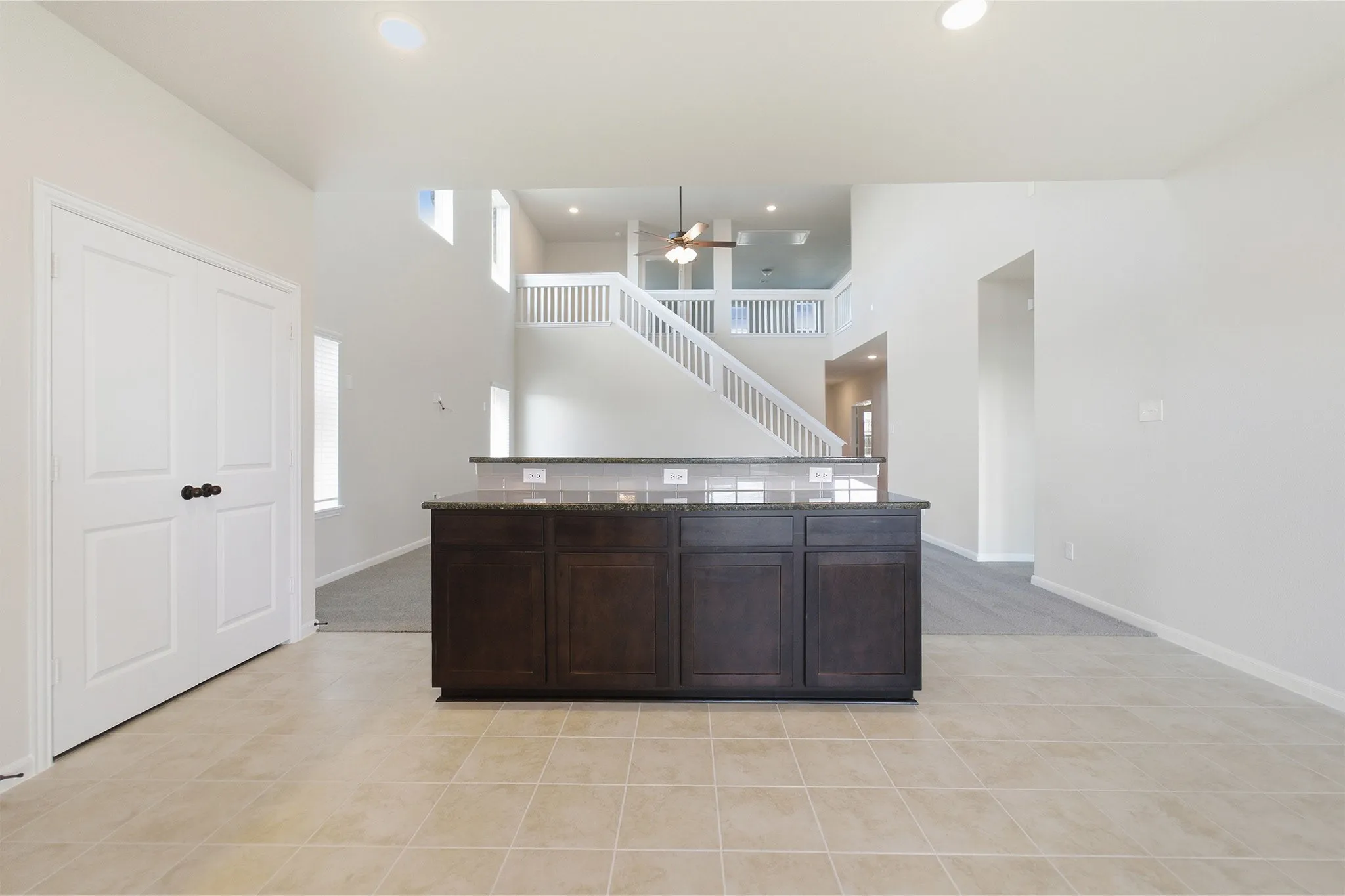 Kitchen island with dark wood cabinetry and a polished stone countertop