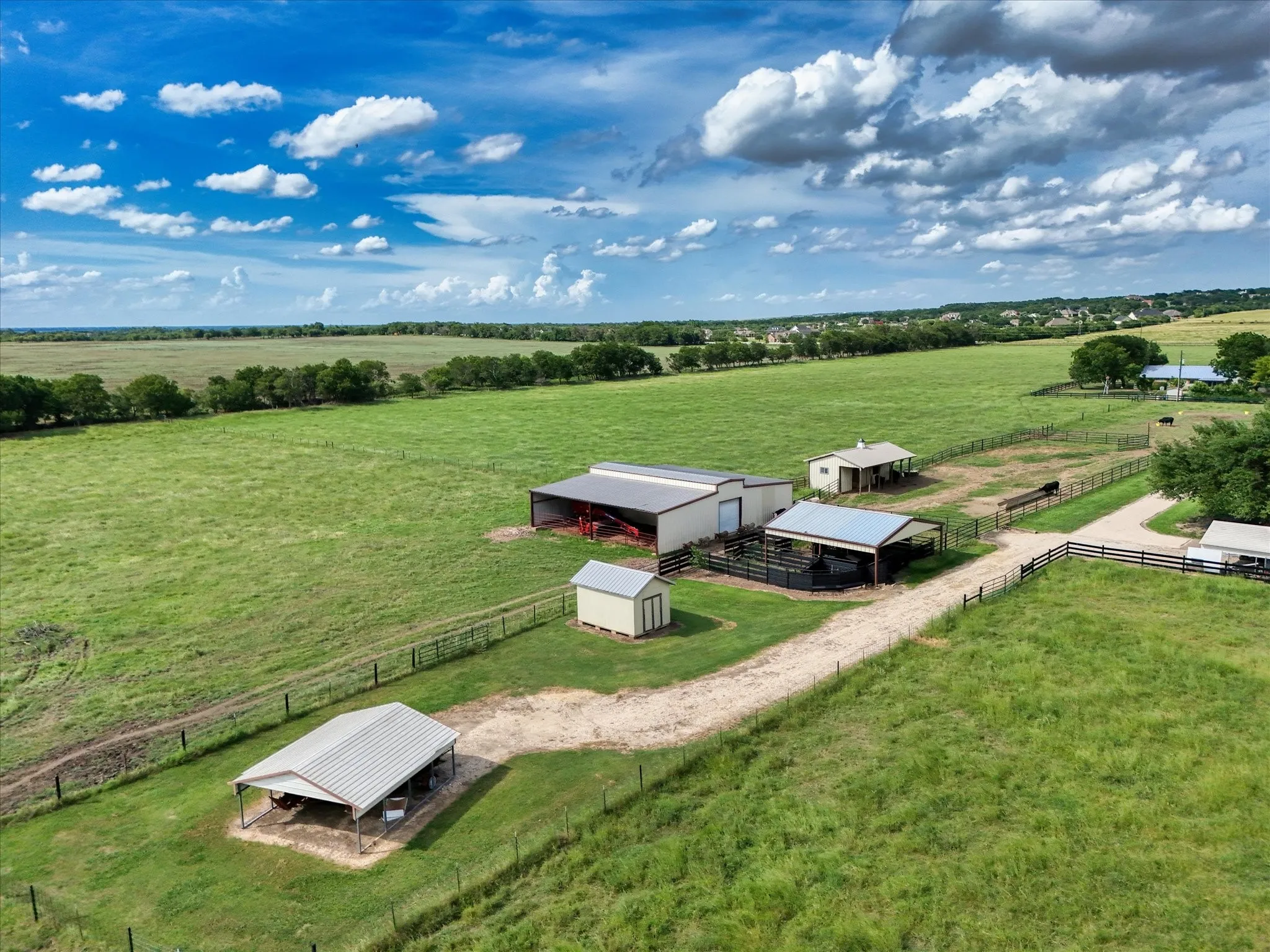 Aerial view of sparsely populated area featuring a pastoral area