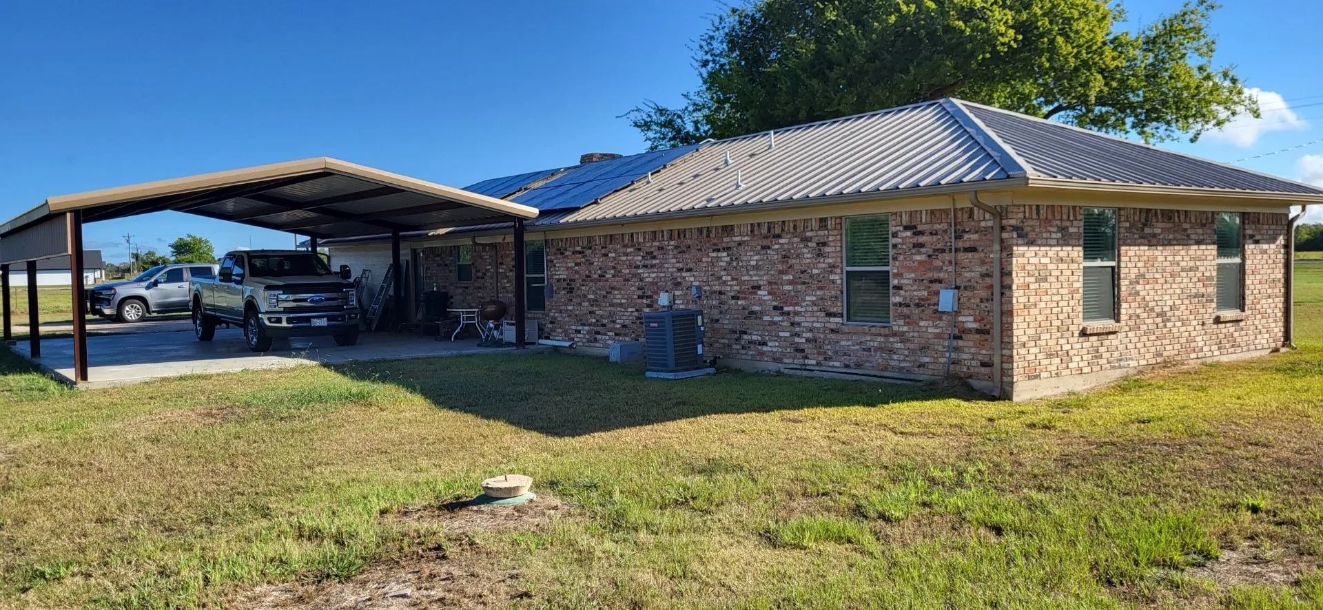 View of side of home with a lawn