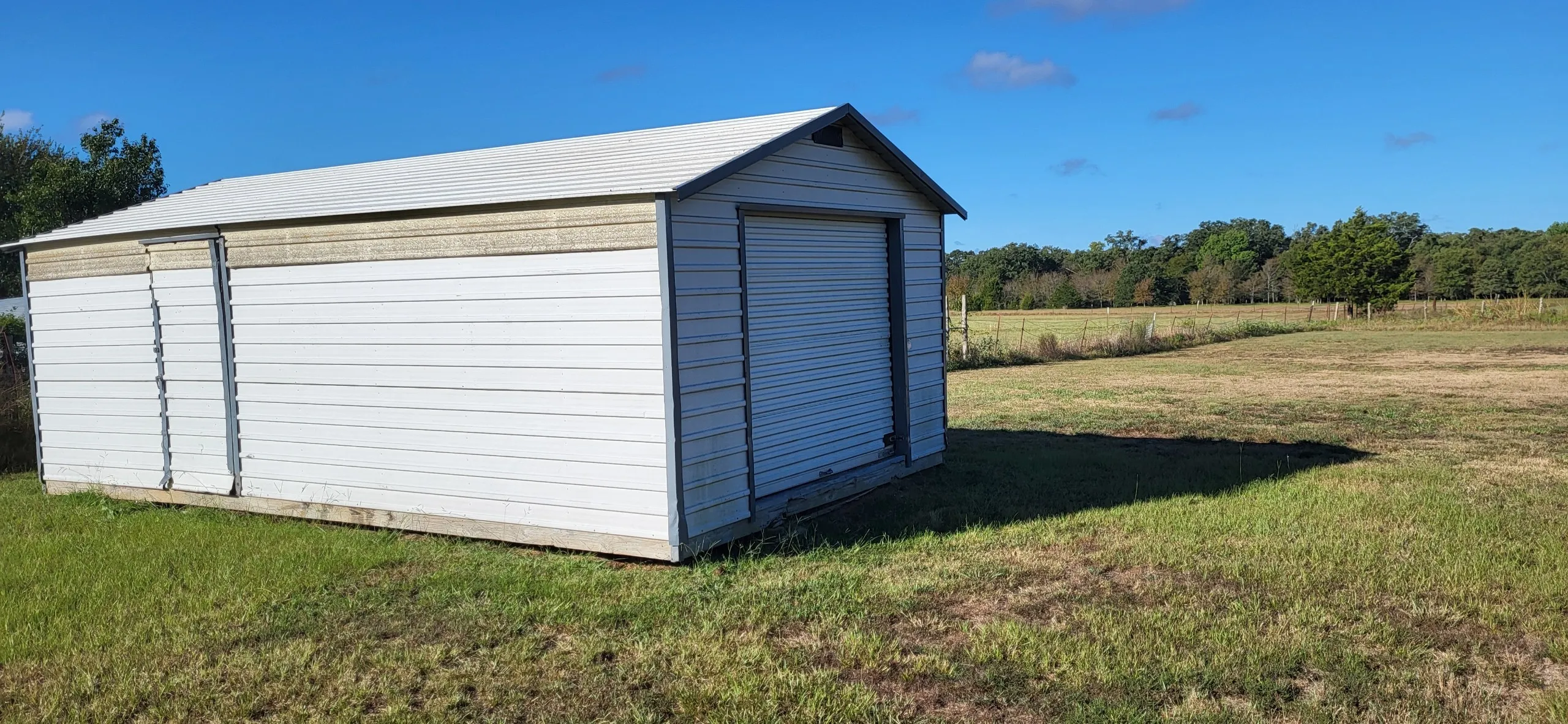View of outdoor structure with a yard