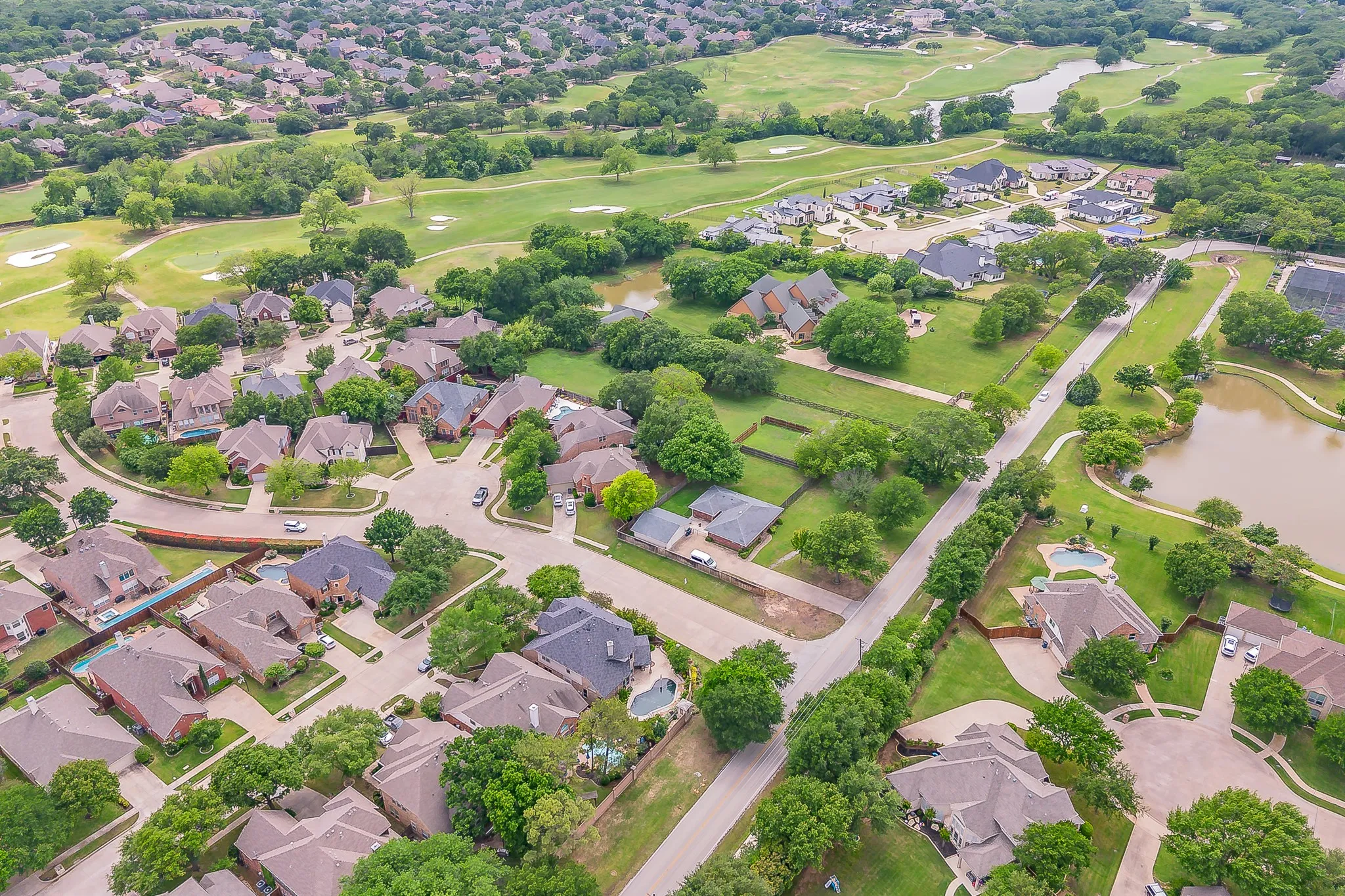Aerial view showcasing a residential community with mature landscaping
