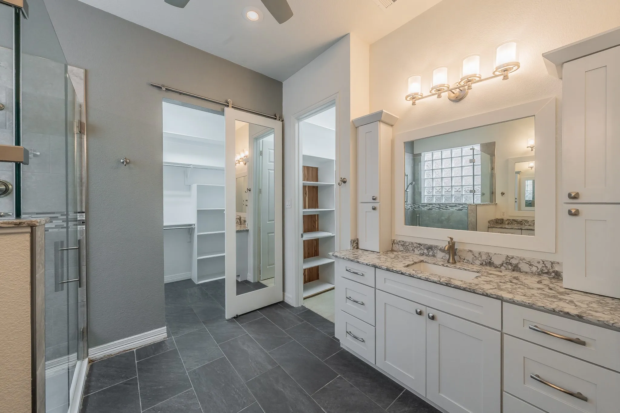 Dual closets both with custom shelving and one cedar lined.