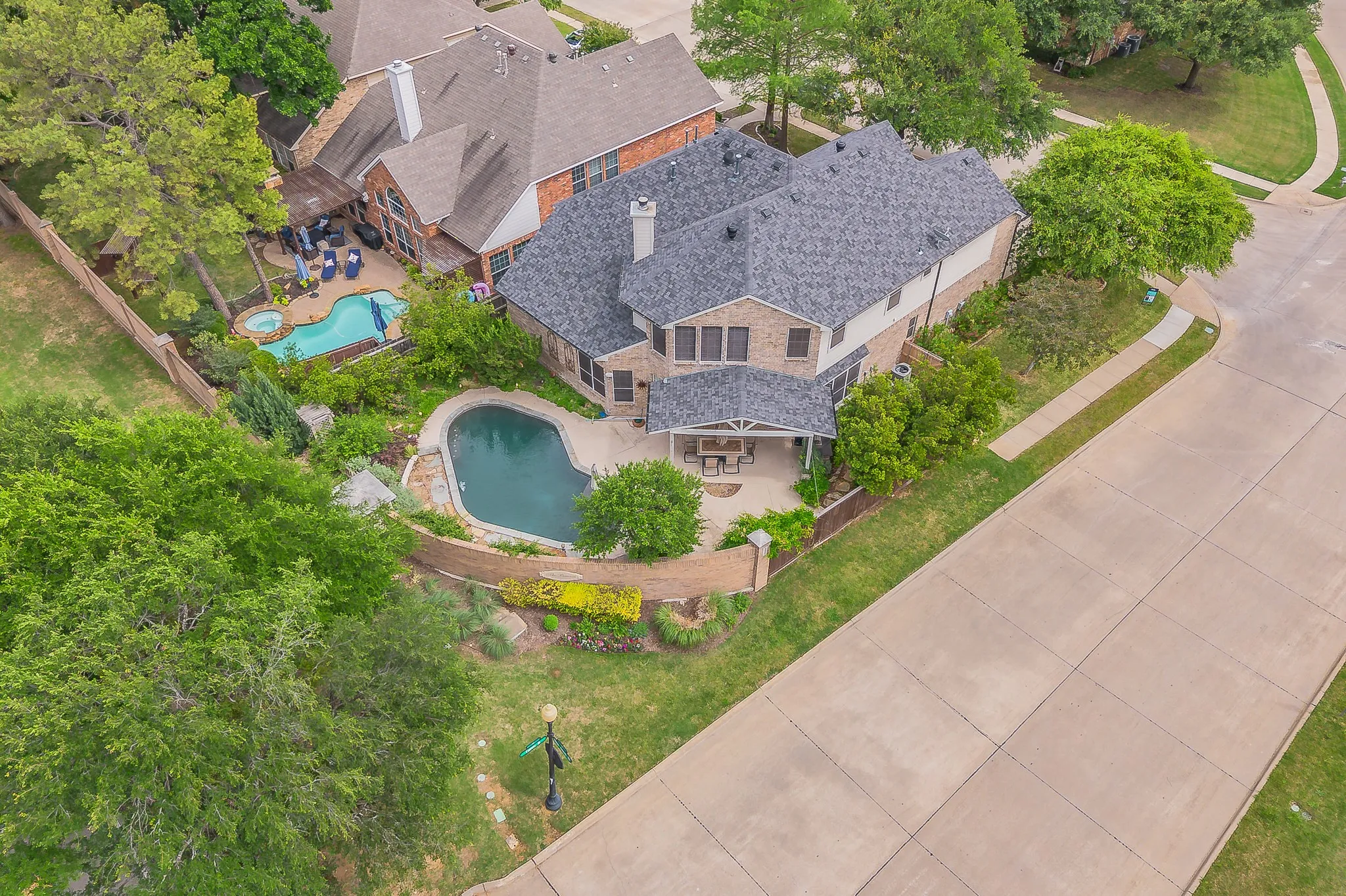 Two-story brick exterior with a dark shingle roof