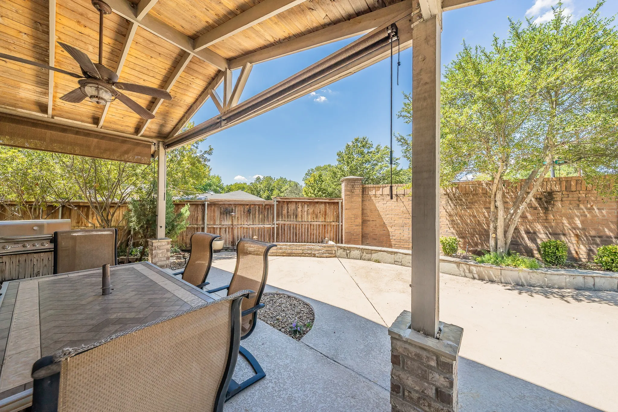 Relax under the covered patio while the grill is fired up for dinner.