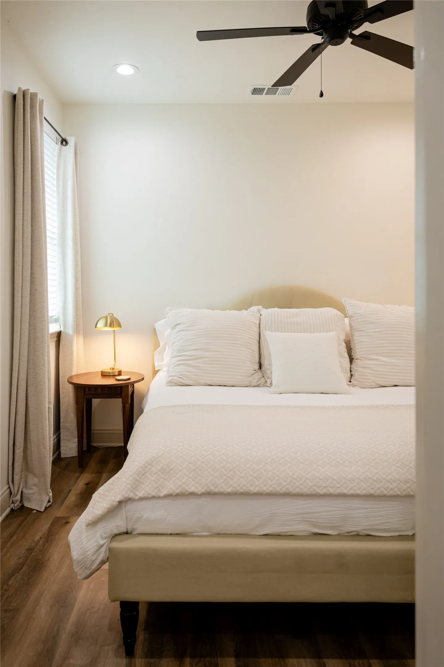 Bedroom featuring dark wood-type flooring and a ceiling fan