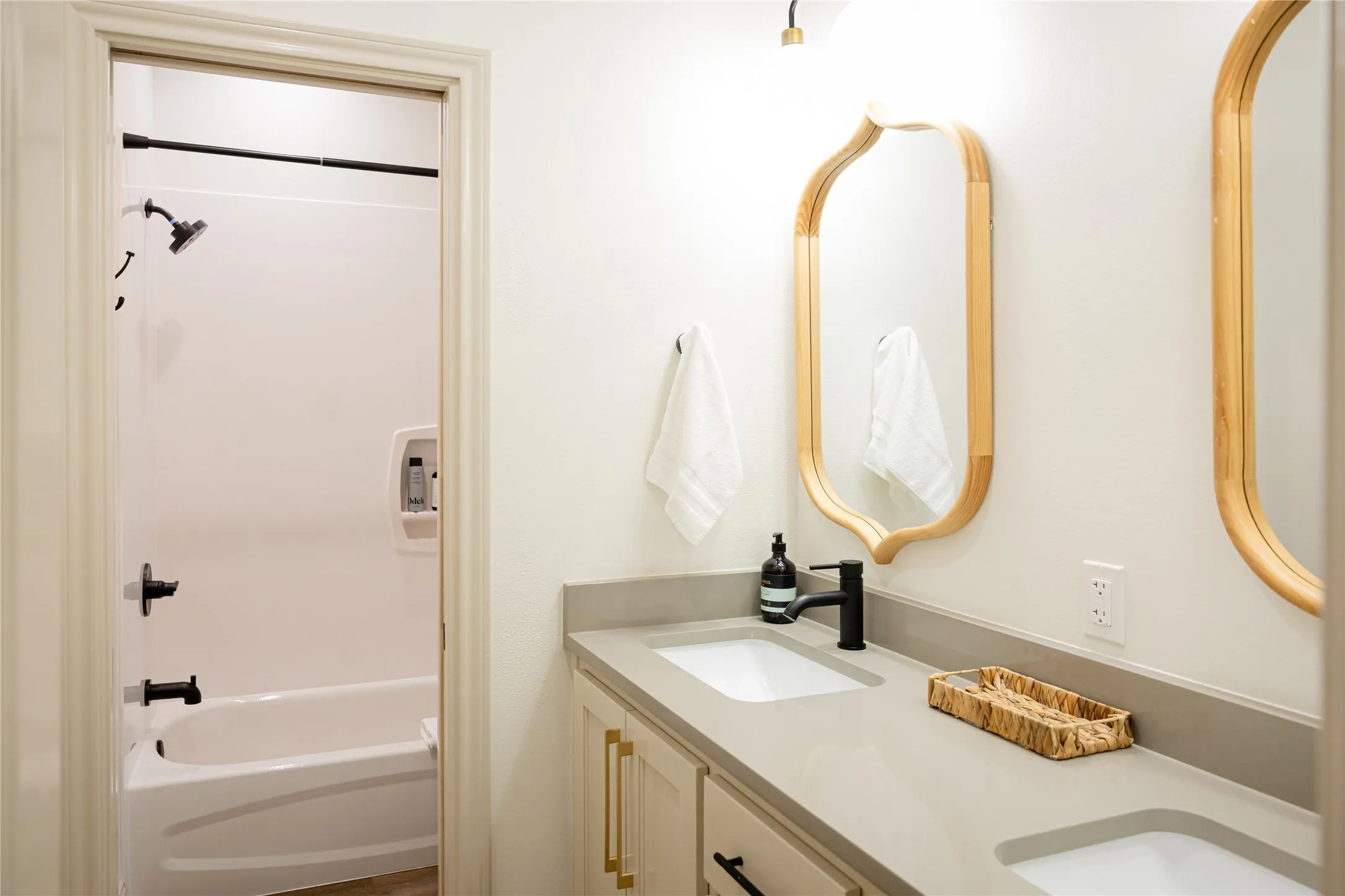 Full bath featuring double vanity and shower / bath combination
