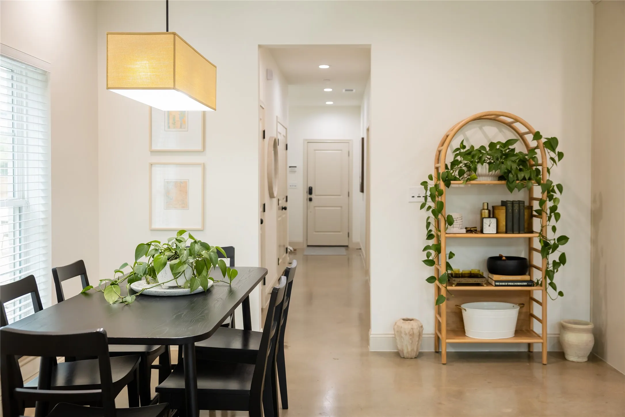 Dining room featuring concrete flooring and baseboards