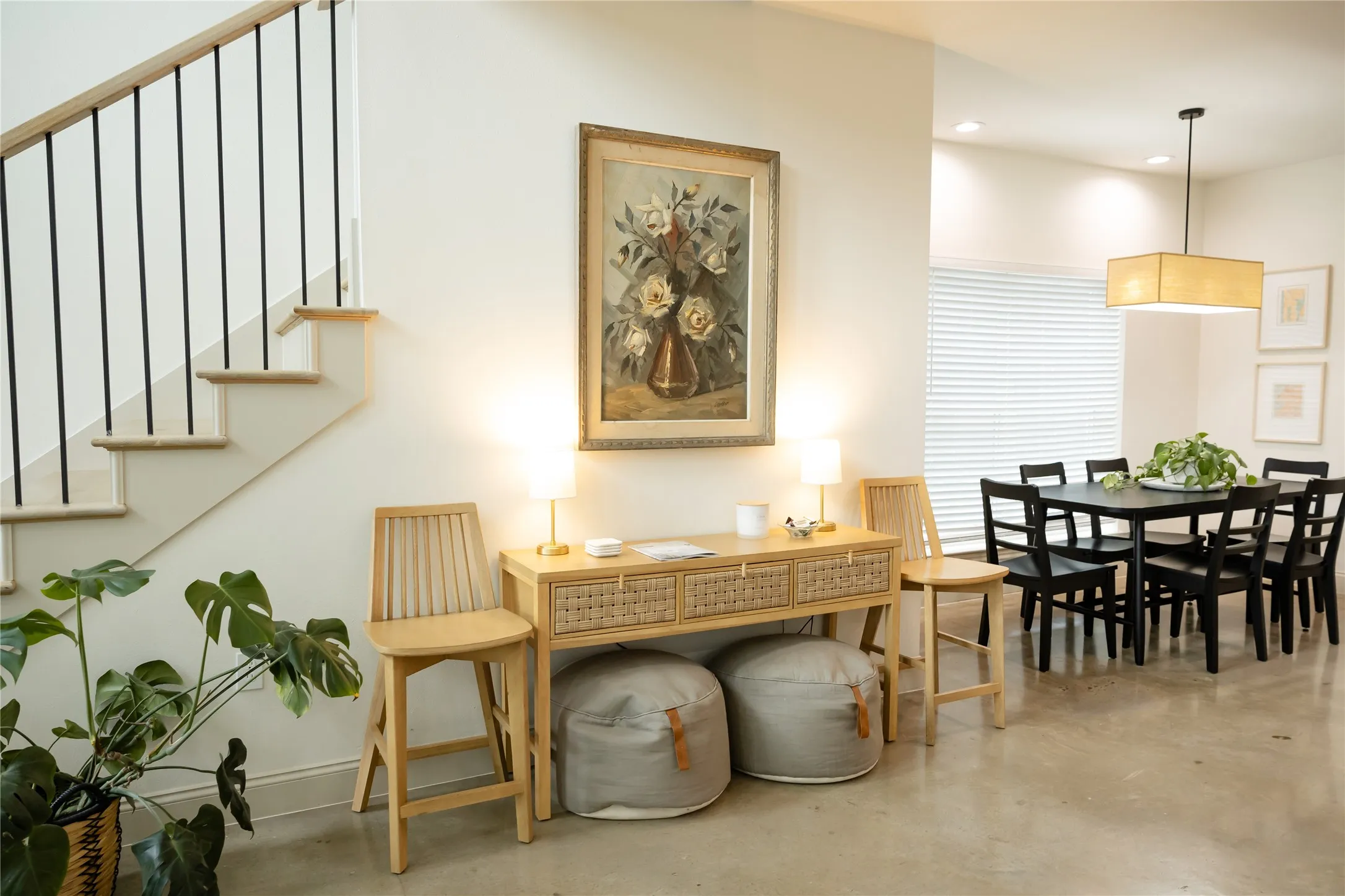 Dining space with concrete floors and stairway