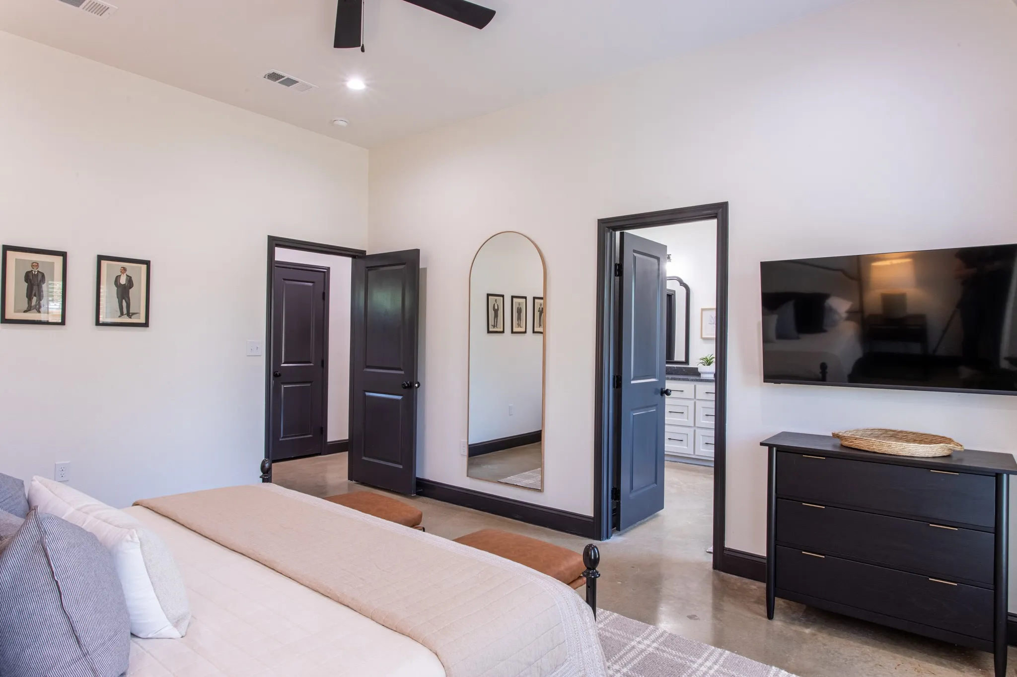 Bedroom with concrete flooring, connected bathroom, ceiling fan, and recessed lighting