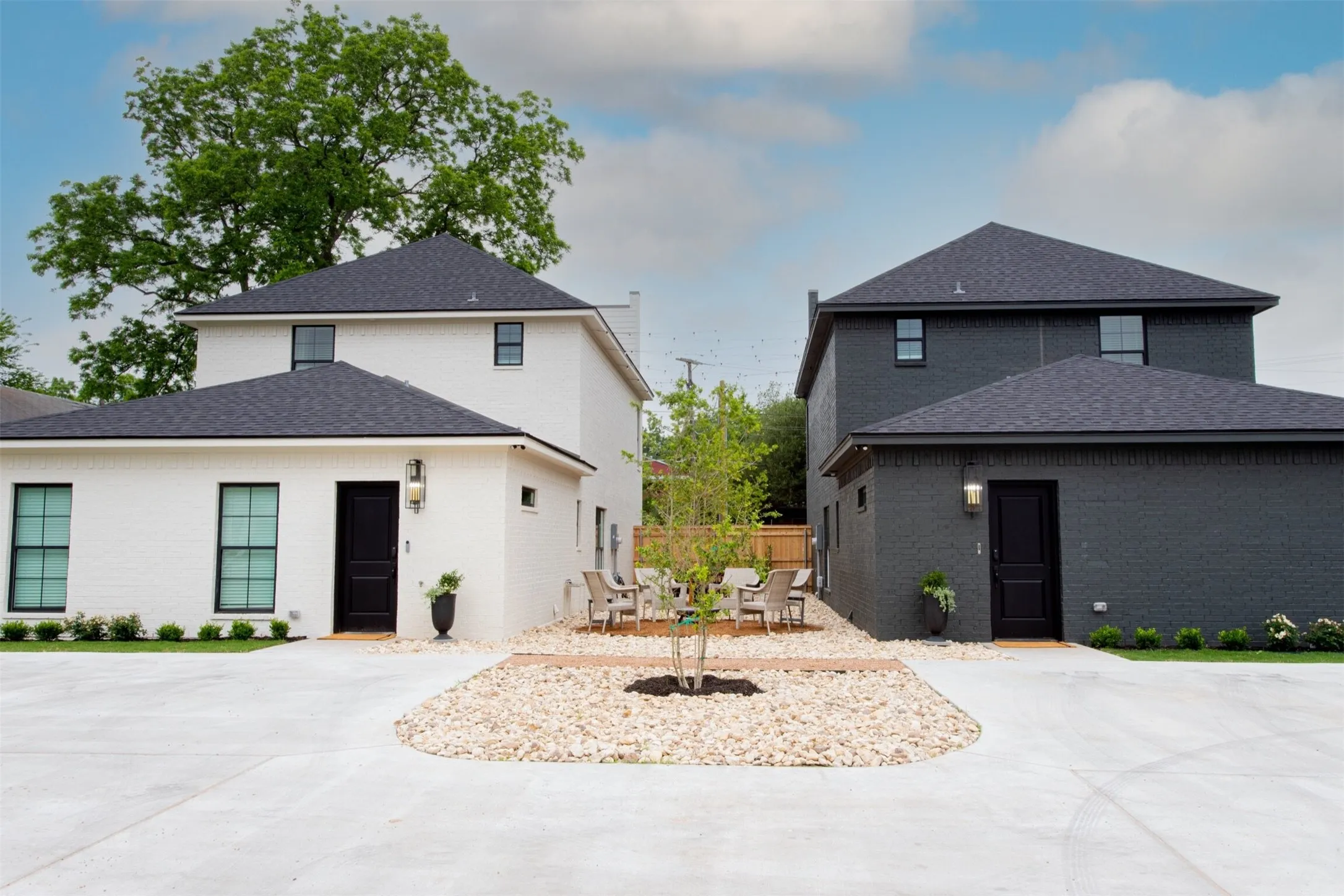 View of front of house featuring brick siding, roof with shingles, and concrete driveway