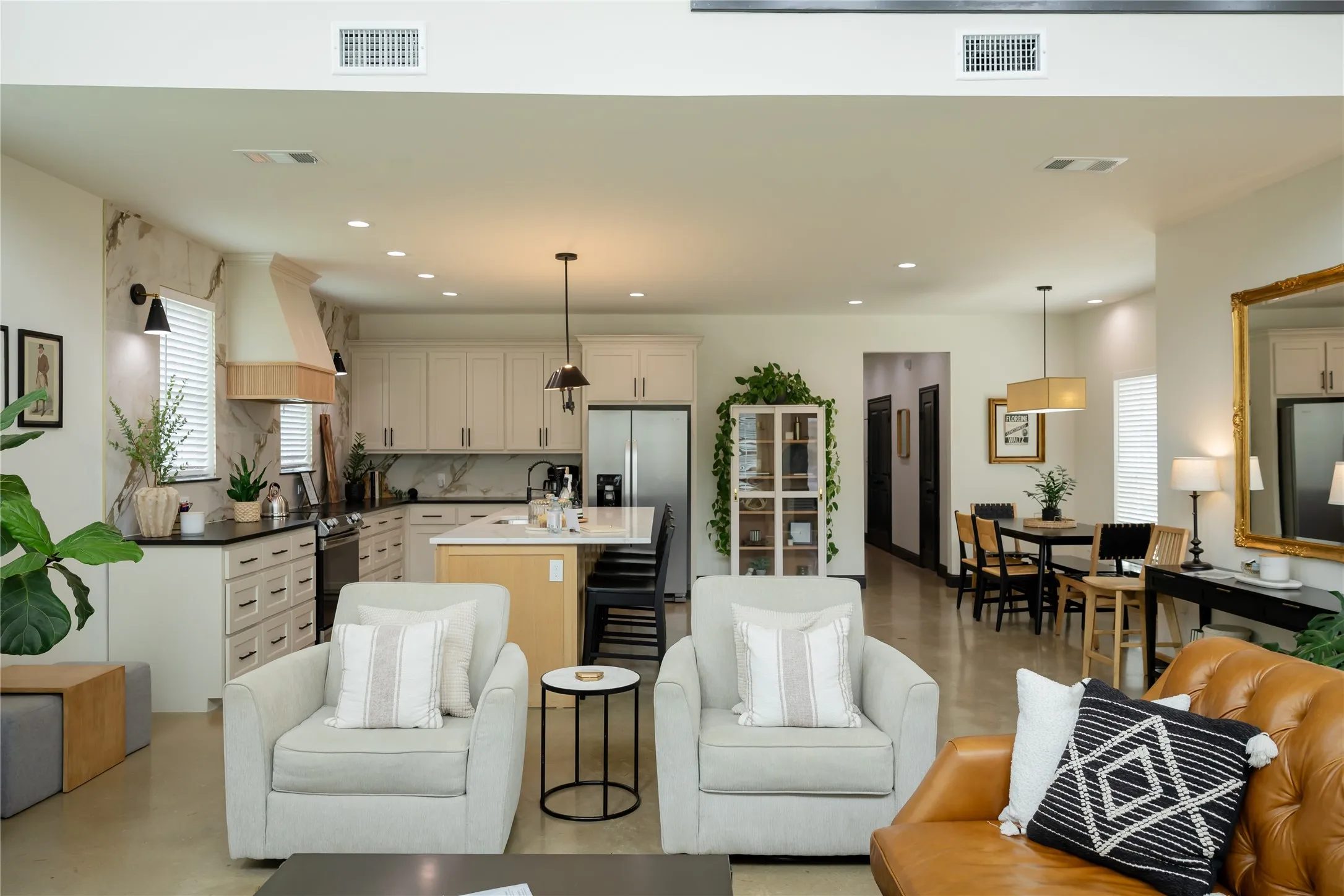 Living area featuring finished concrete floors and recessed lighting