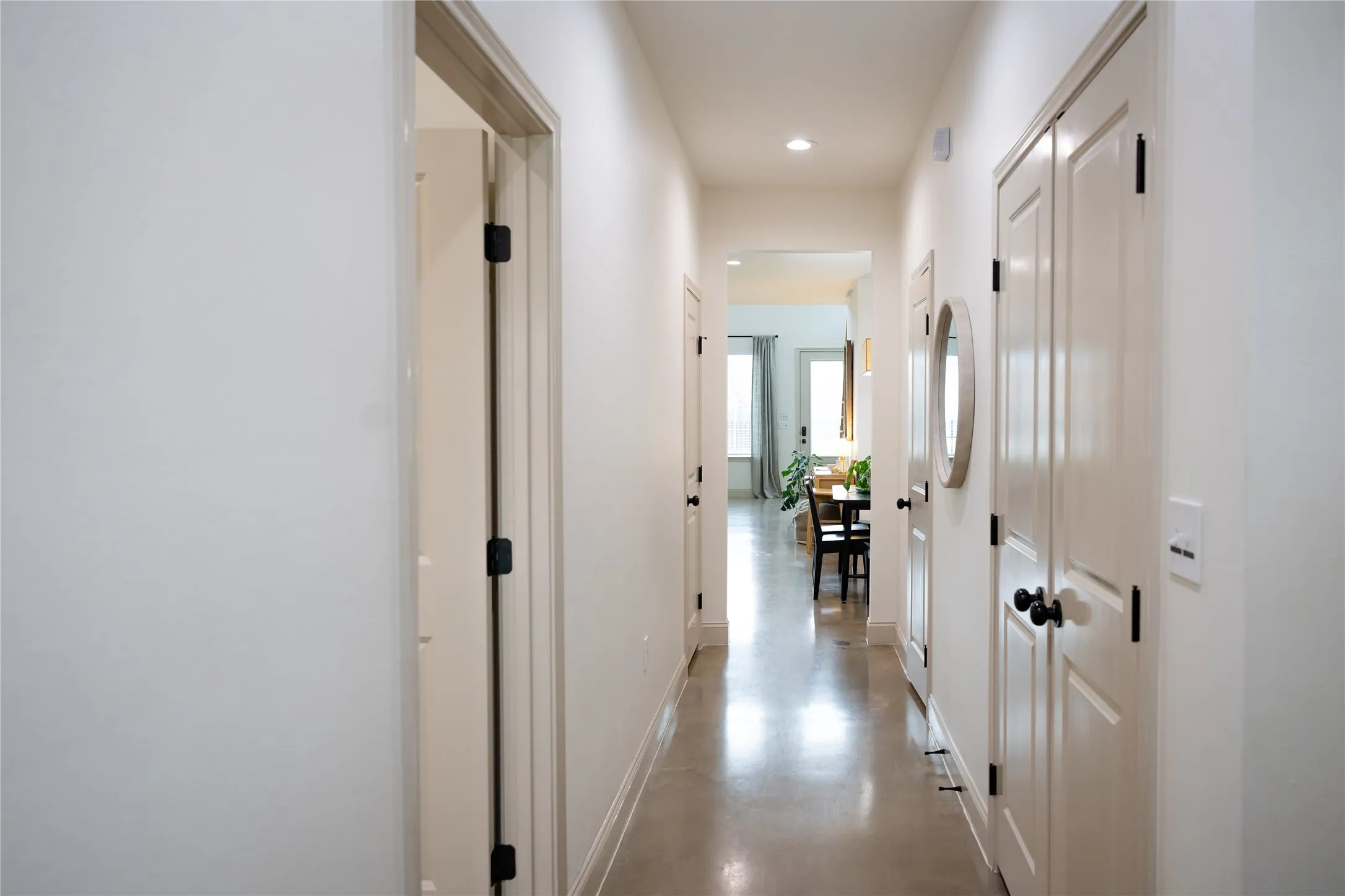 Hall featuring finished concrete floors and recessed lighting