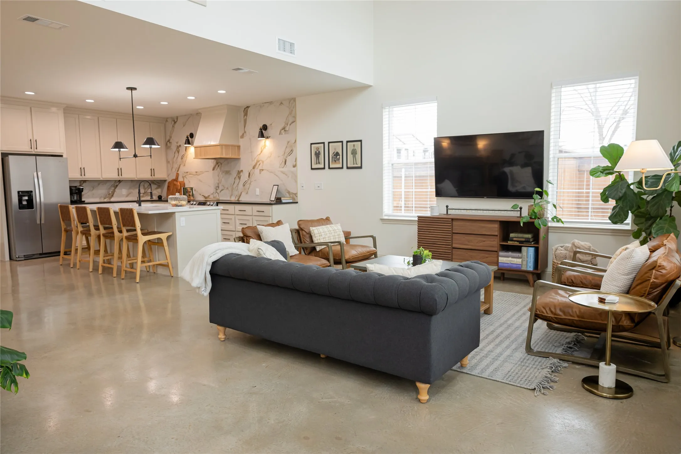 Living area featuring finished concrete floors and recessed lighting