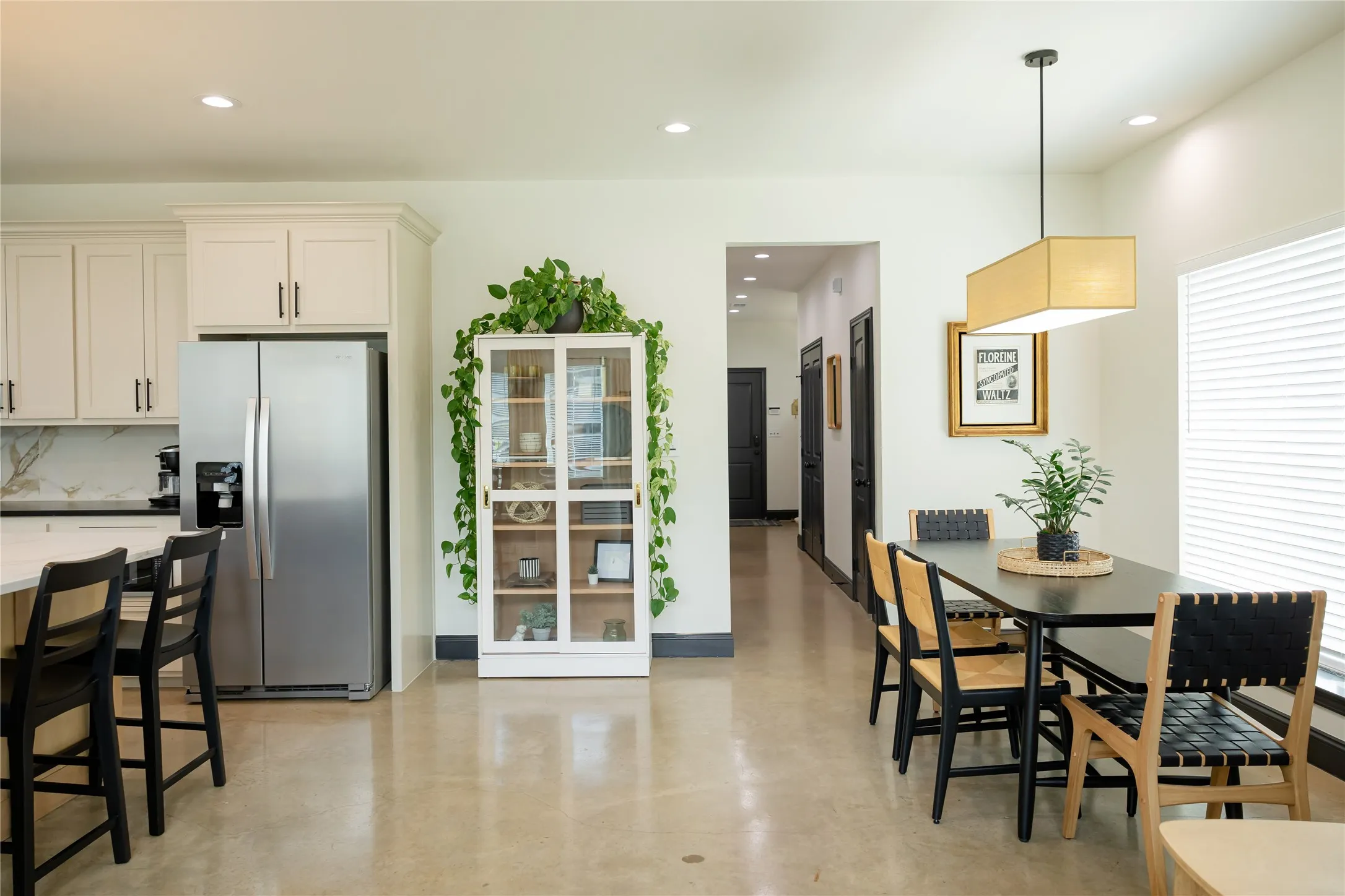 Dining area with concrete flooring and recessed lighting