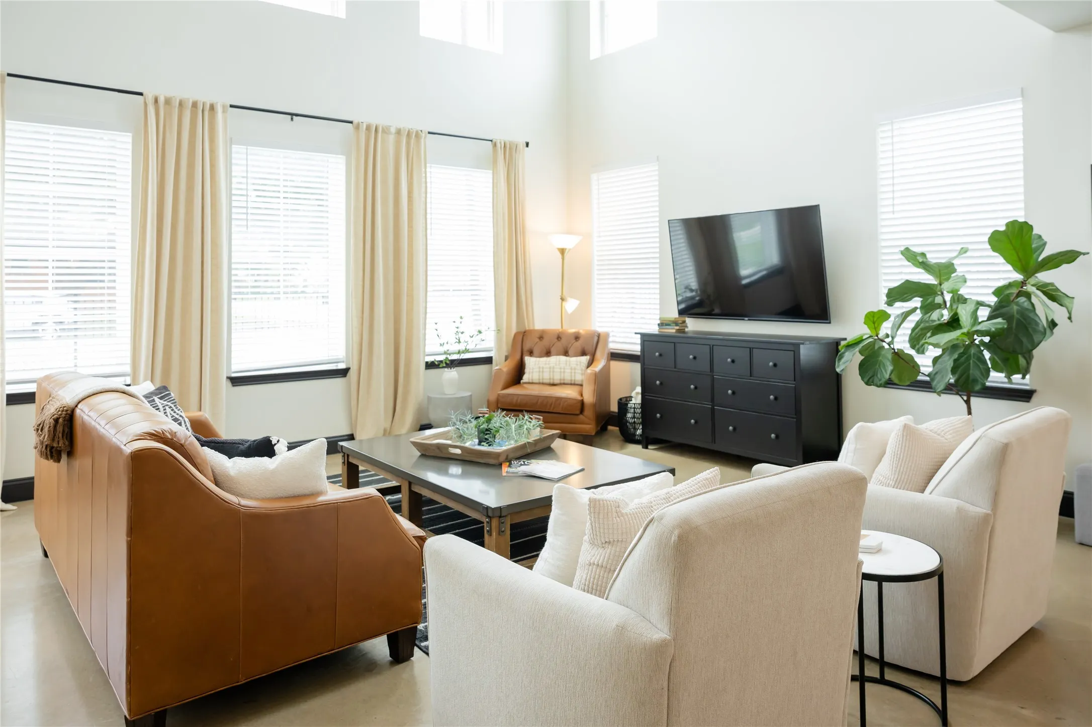 Living area with a high ceiling and concrete flooring