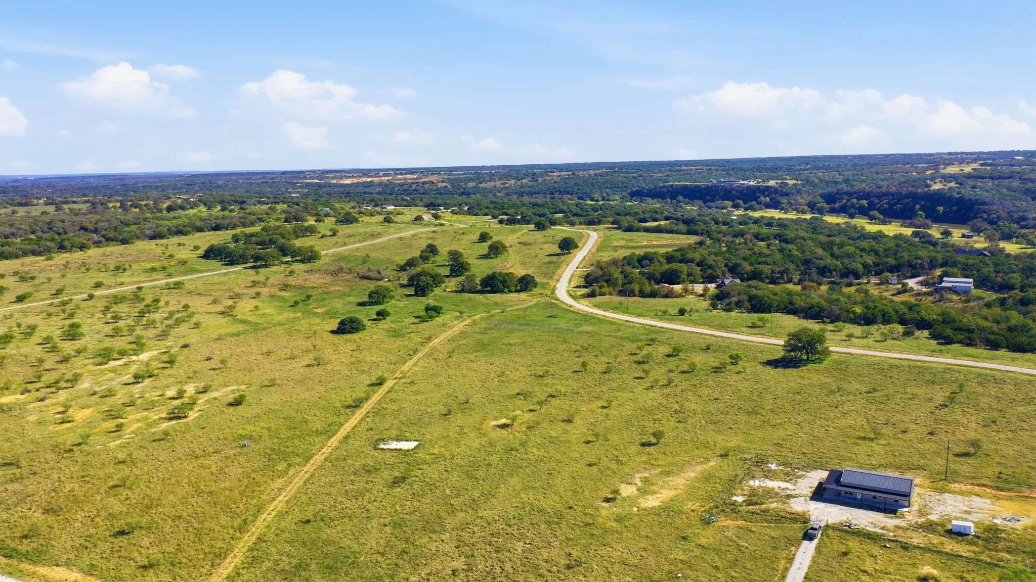 Aerial view of property and surrounding area featuring rural landscape