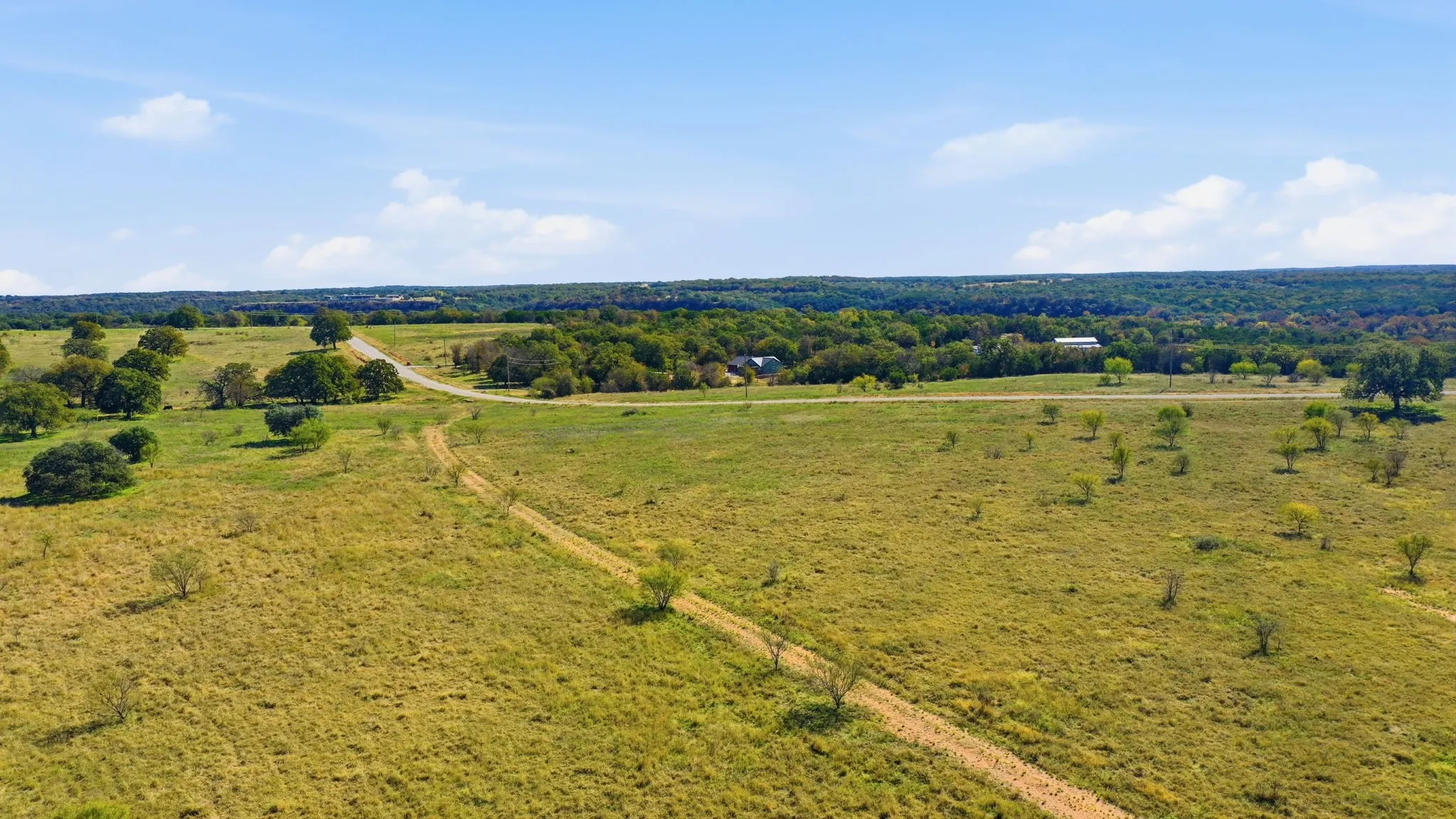 Aerial view of sparsely populated area featuring a pastoral area
