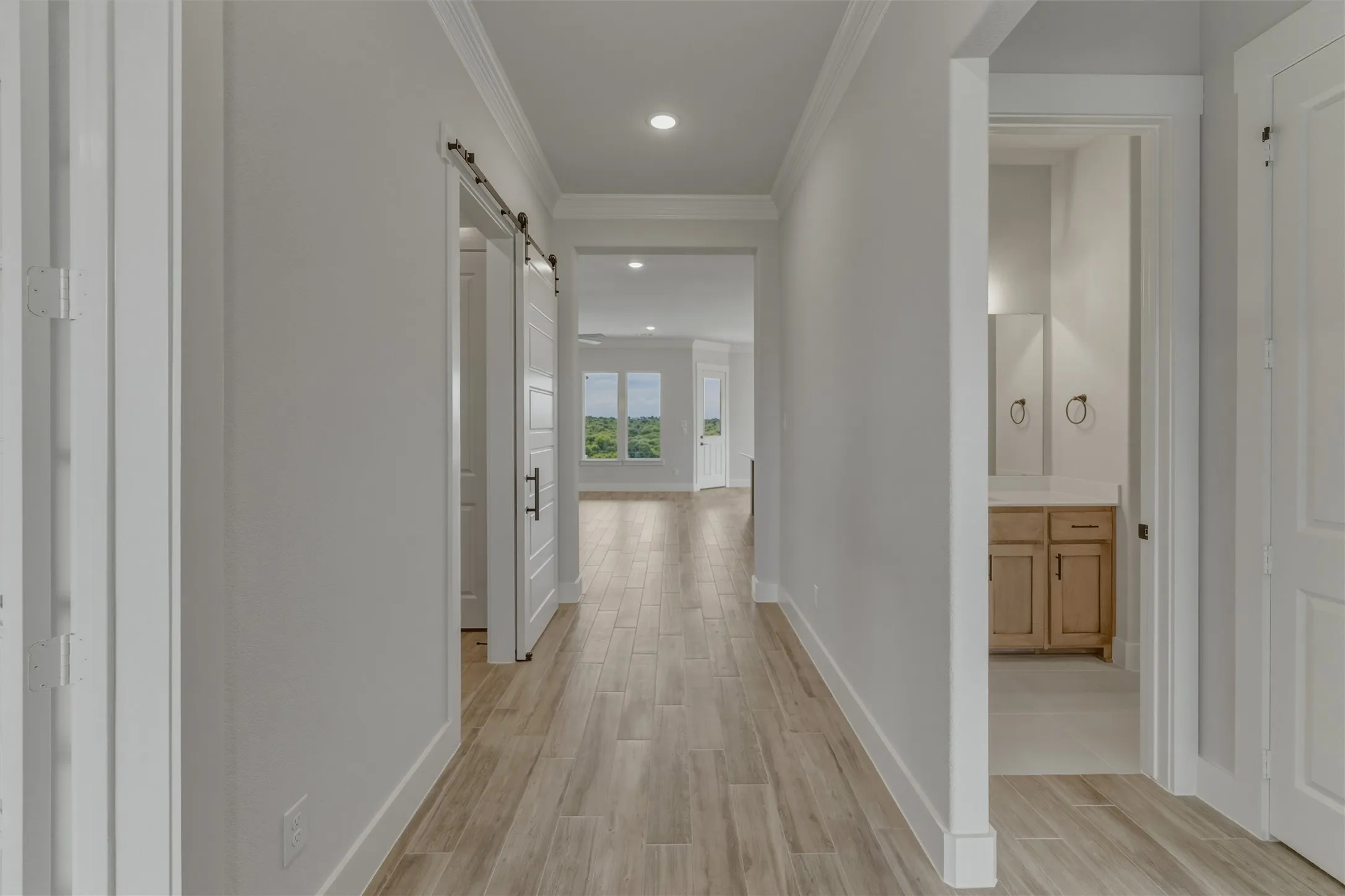 Hallway with wood-finish tile flooring, recessed lighting, and crown molding