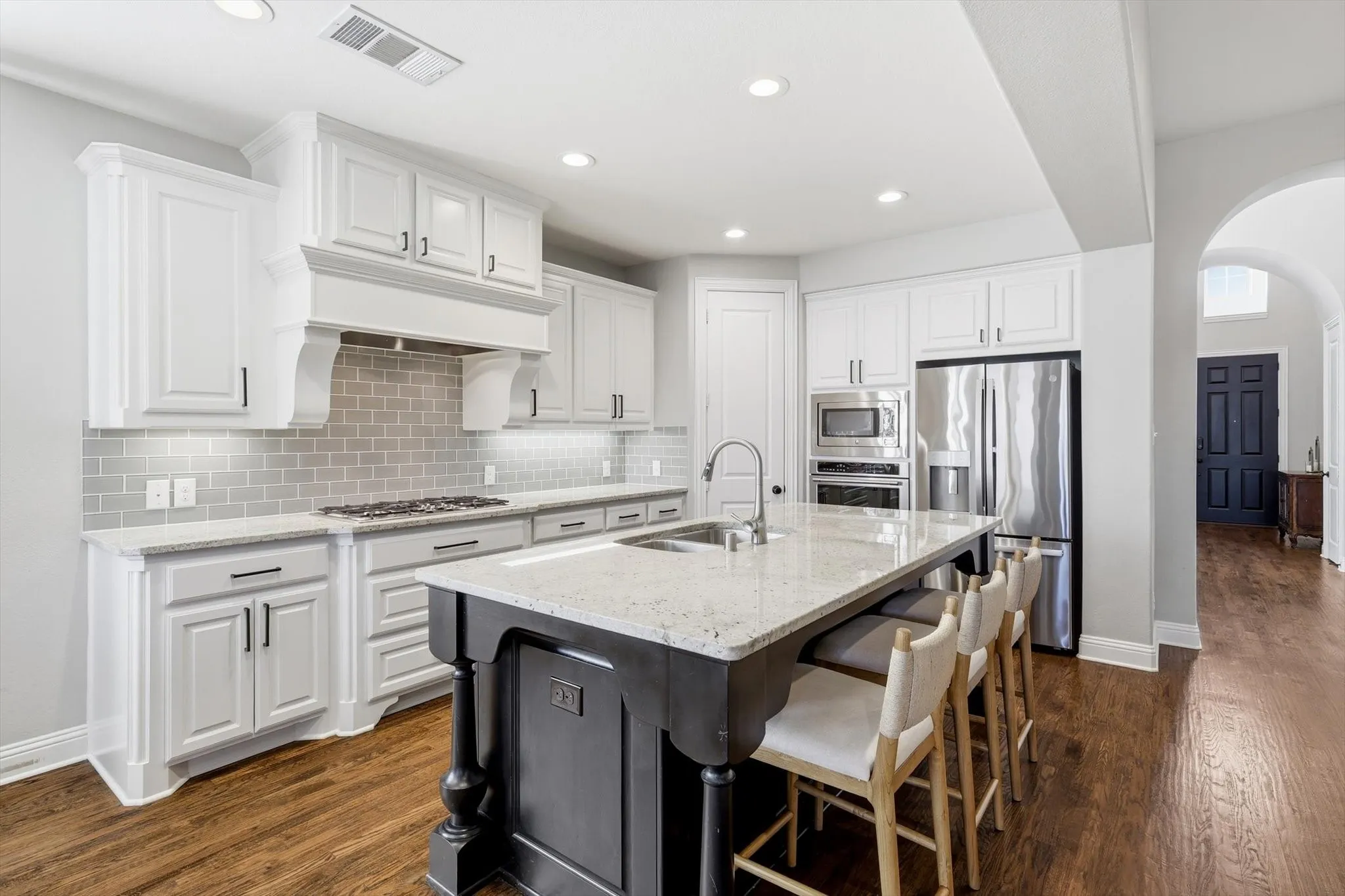 Kitchen with white cabinetry and large island
