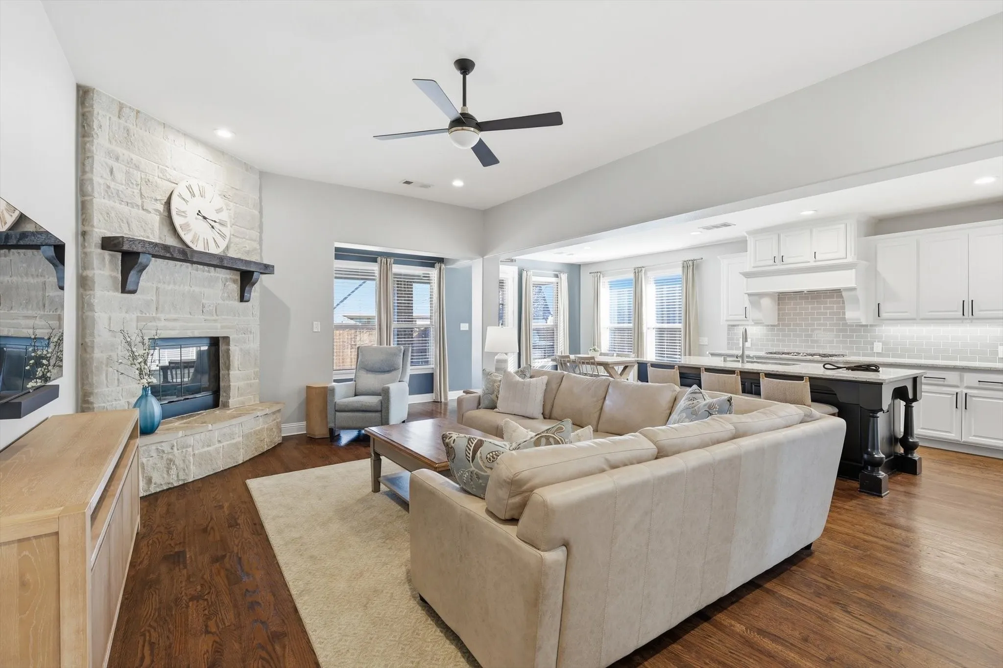 Open concept living room with feature stone fireplace
