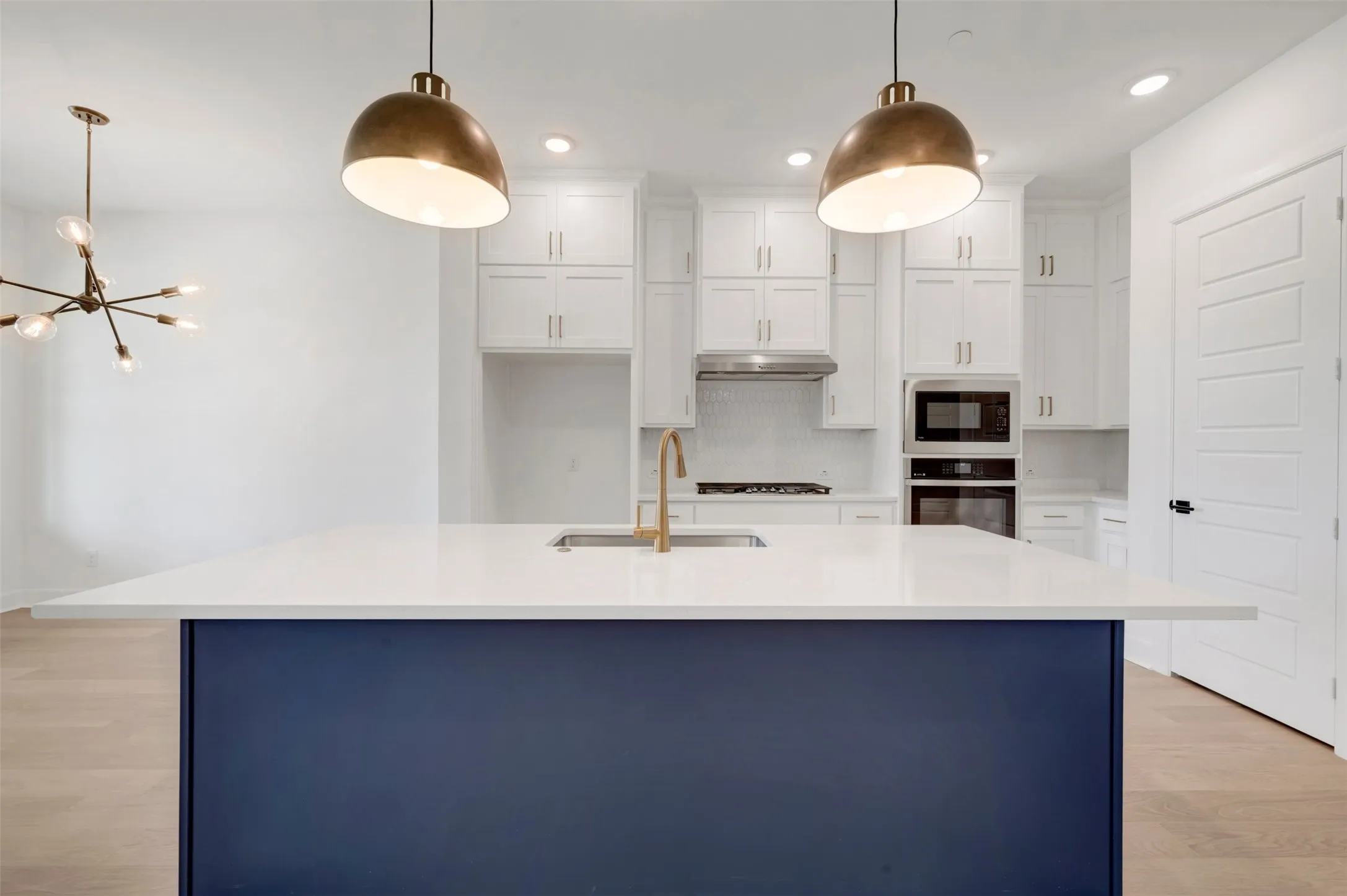 Kitchen island with a white countertop and contrasting blue base