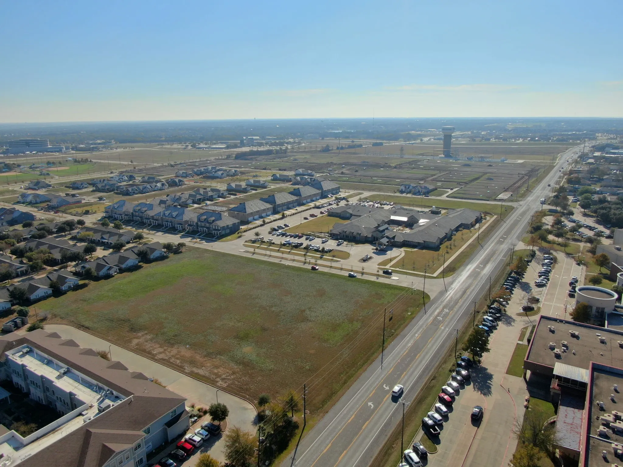 Aerial side view showing the parcel's generous dimensions and proximity to surrounding commercial growth.