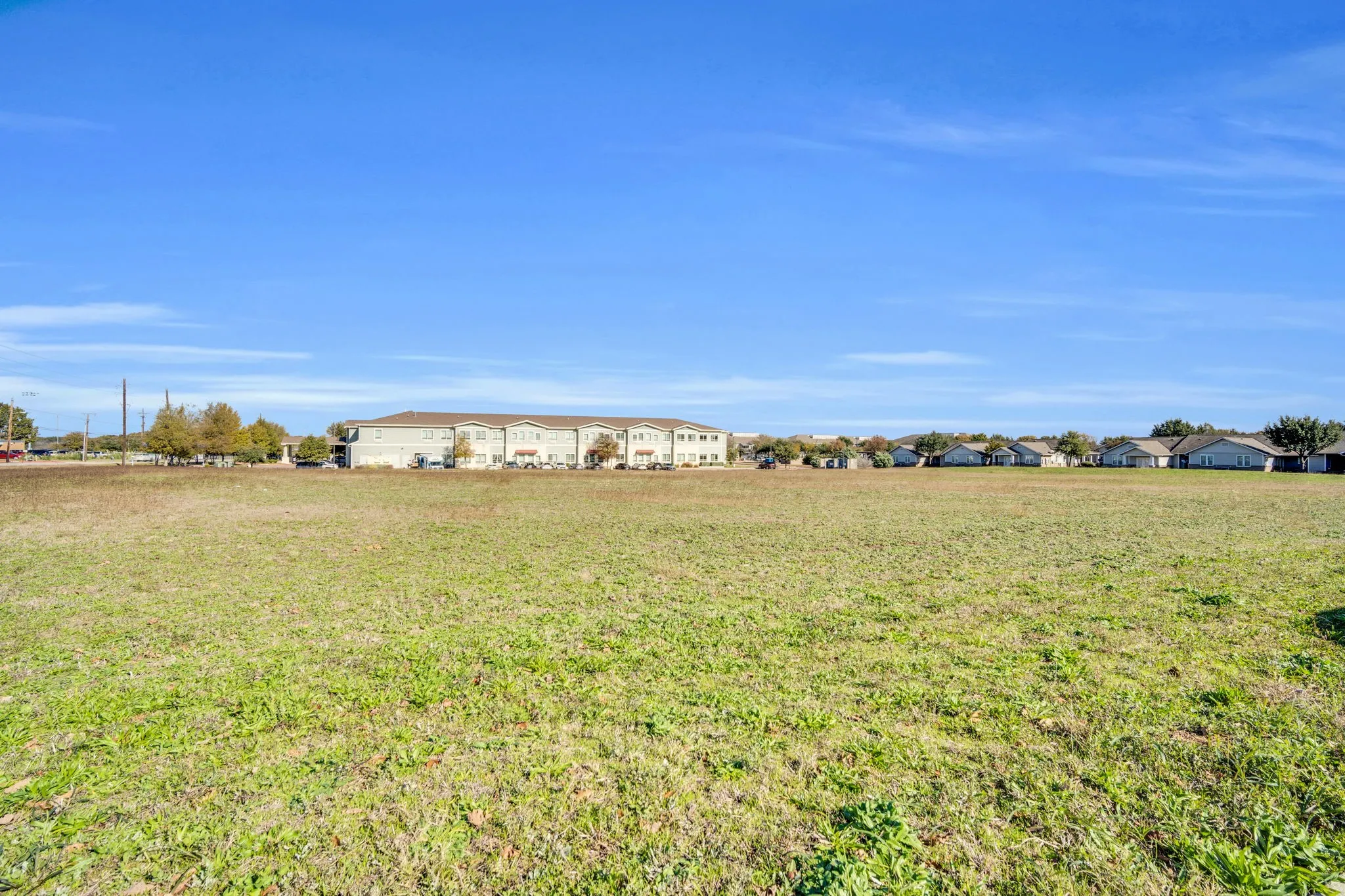Ground view of the property highlighting its open, level topography, ideal for a variety of commercial uses.