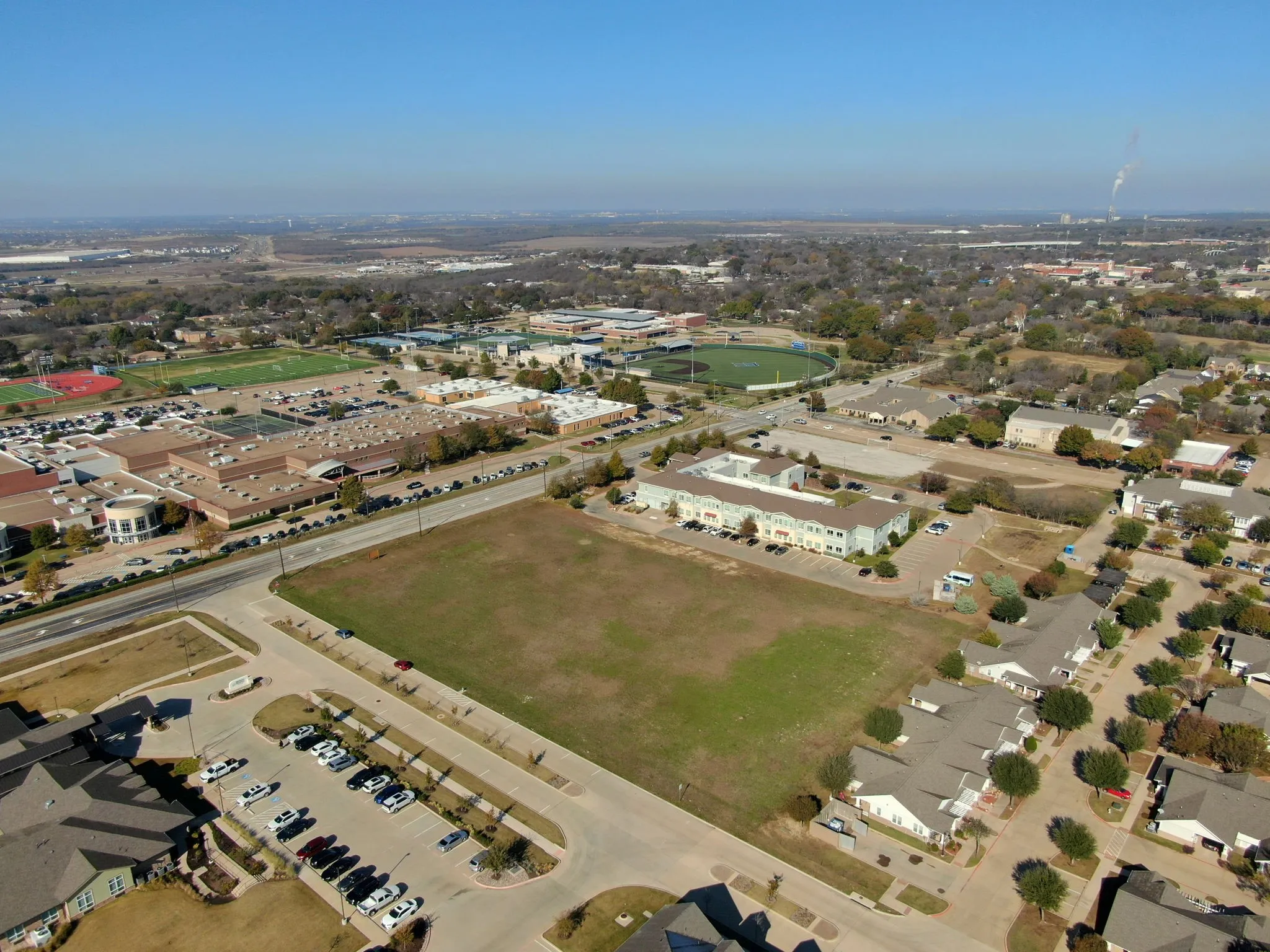 Wider aerial perspective illustrating the property's prime location within a rapidly growing commercial corridor.