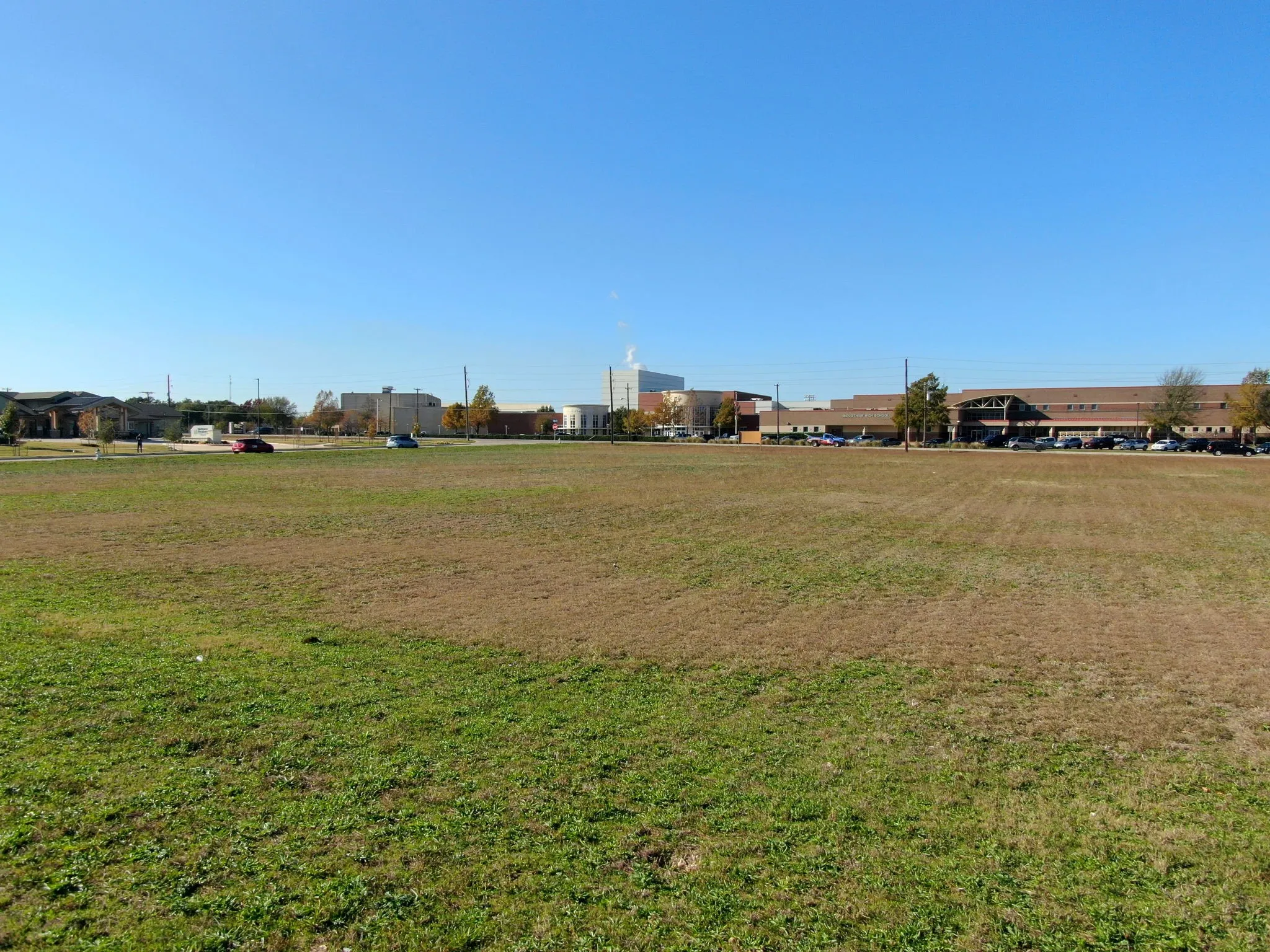 Ground-level view of the property, offering a true sense of its scale and road frontage.