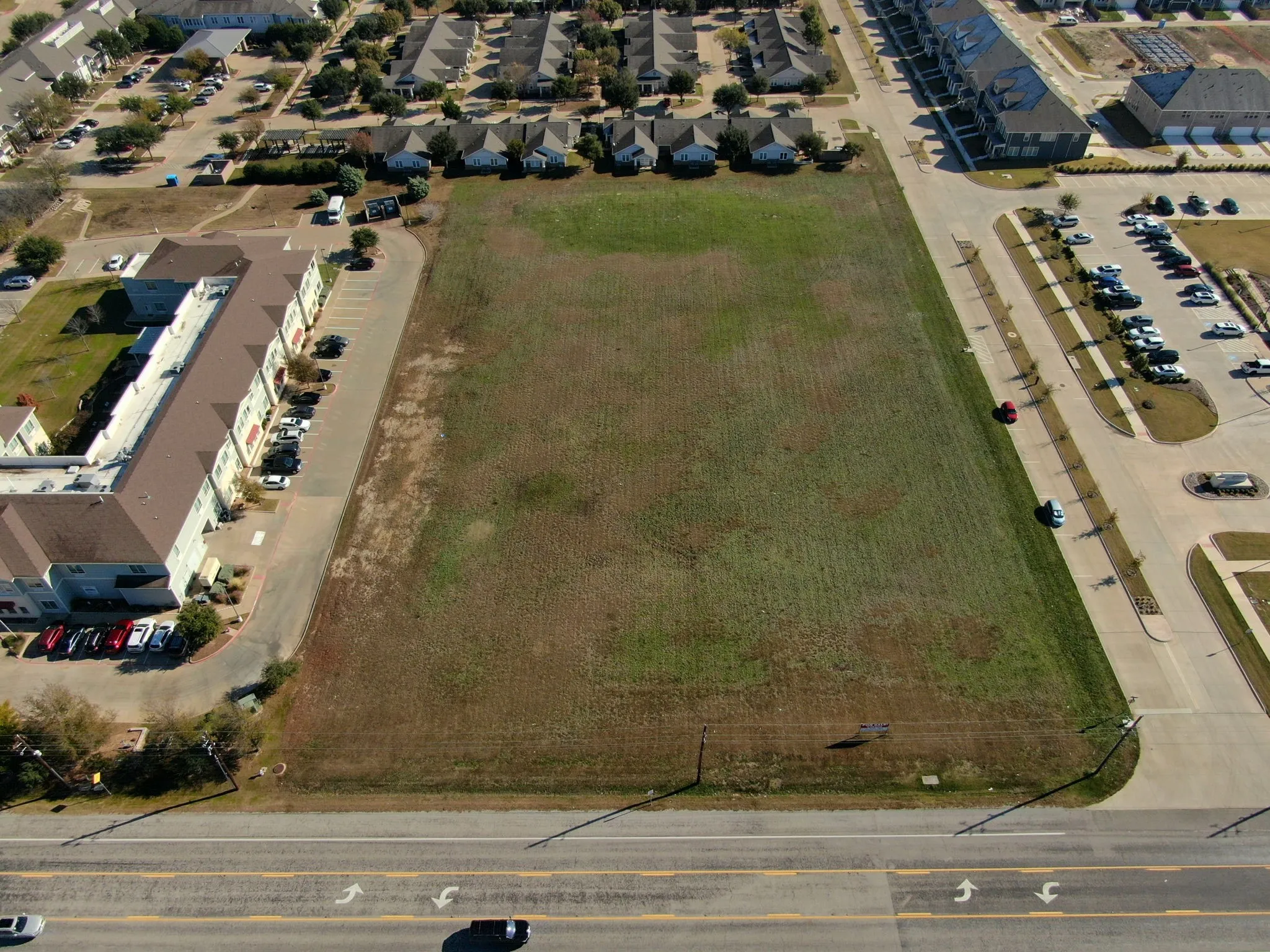 Aerial view capturing the property's frontage along a well-traveled roadway, perfect for high visibility.