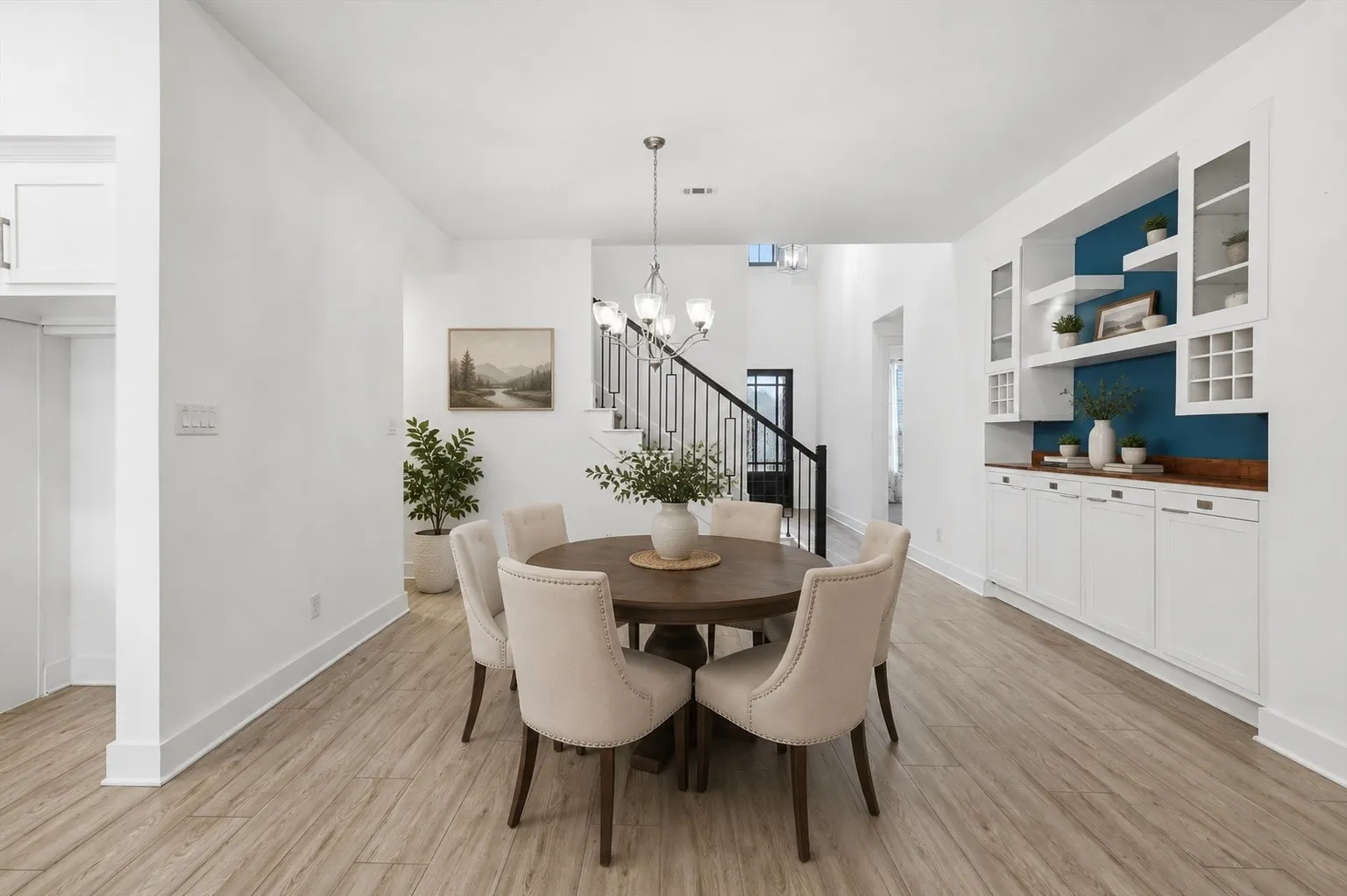 Open Concept dinning space with built in cabinets with lighting and glass fronts, inclusive of soft close cabinets. *virtual staging