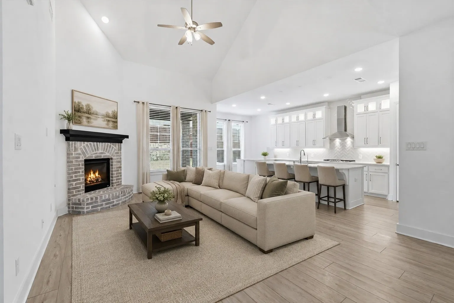 LVP Flooring, White Cabinets with glass uppers for decorating, Gas fireplace in living and tons of natural lighting *virtually staged