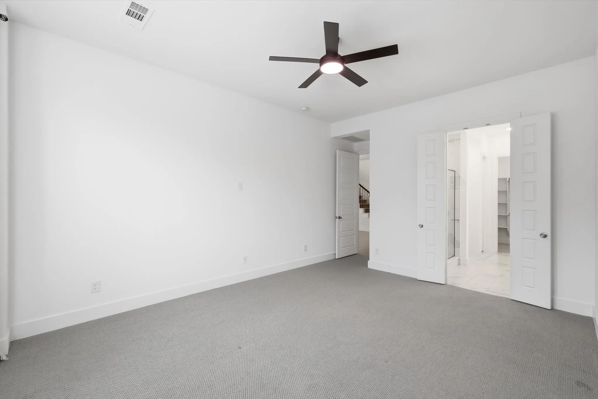 Large Primary on first level with bay windows, sitting room, fan and upgraded carpet