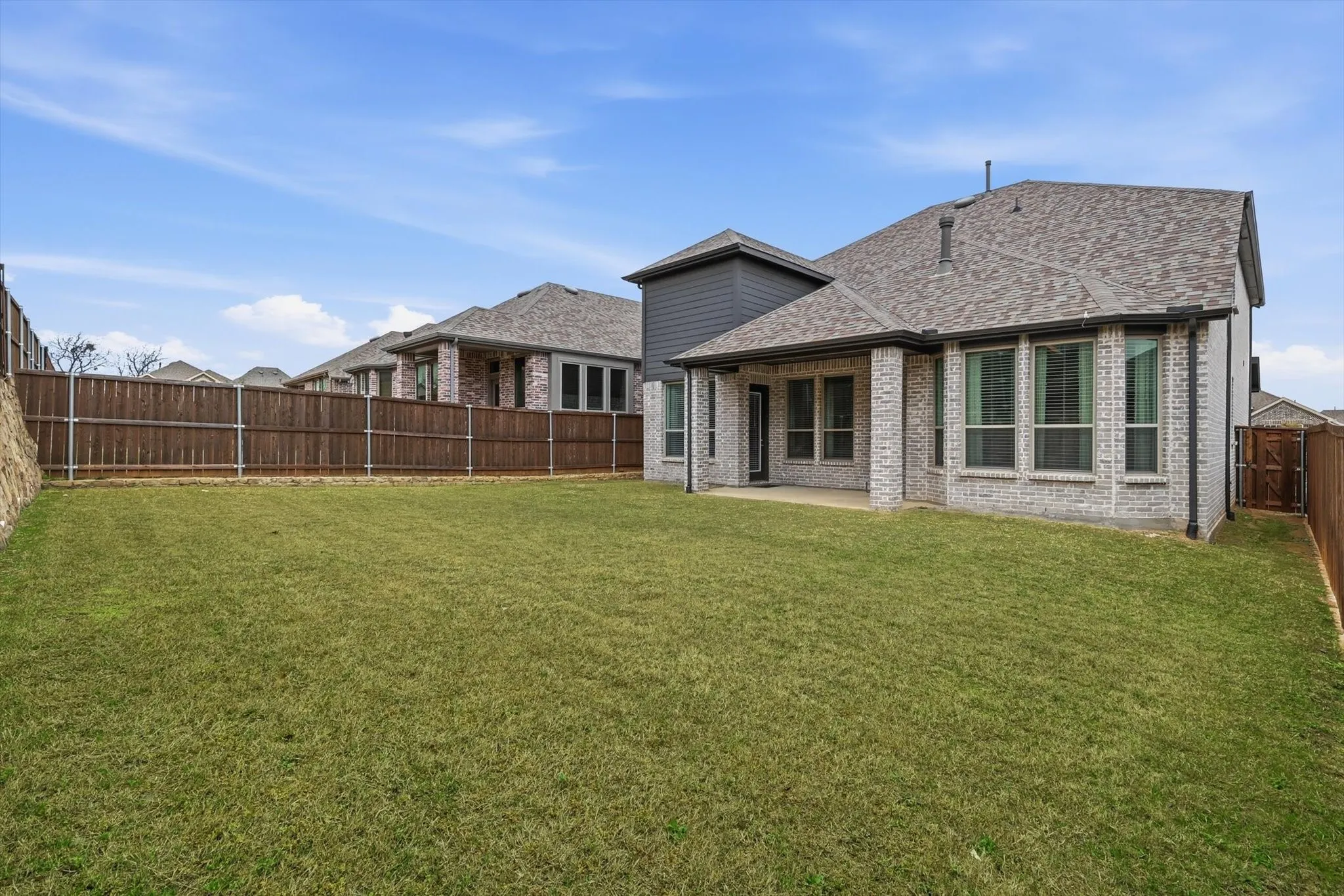 Back of home with large covered patio, EXTREMELY private with fencing and placement!