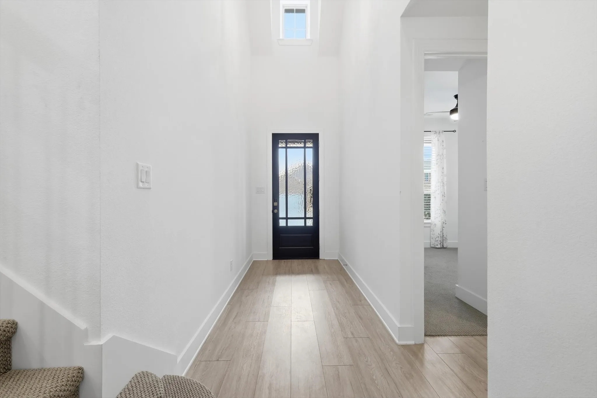 Large Open Foyer with Elevated Ceilings spanning to the second level with balconies. LVP flooring throughout livings spaces.
