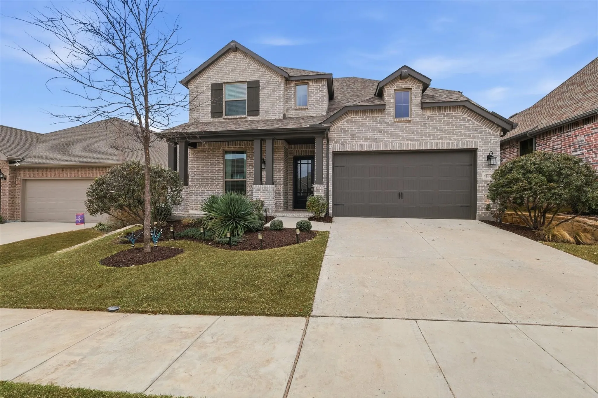 Beautiful front view of the home with fresh landscaping, front patio for coffee and stunning evenings!