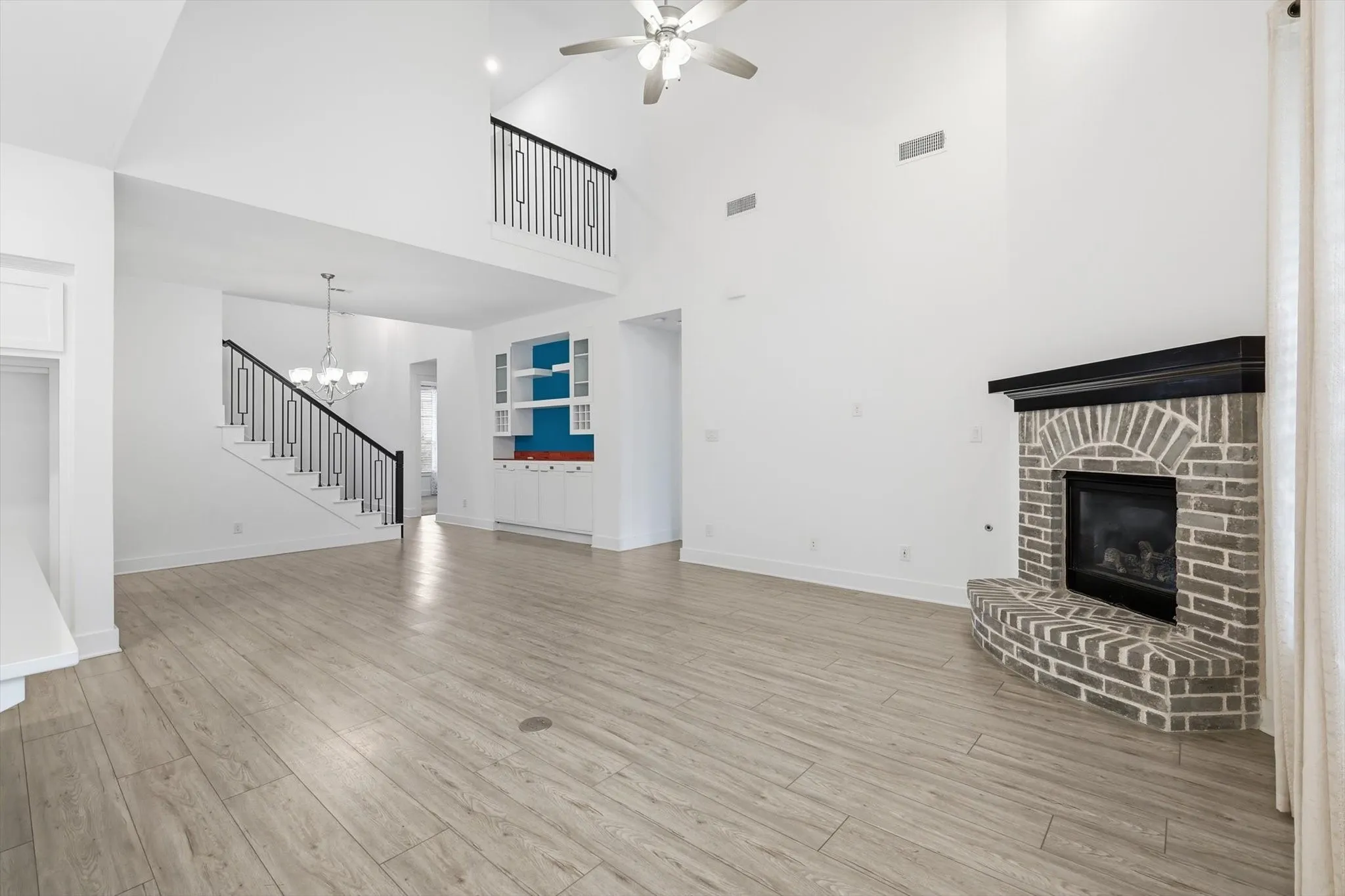 LVP Flooring, White Cabinets with glass uppers for decorating, Gas fireplace in living and tons of natural lighting