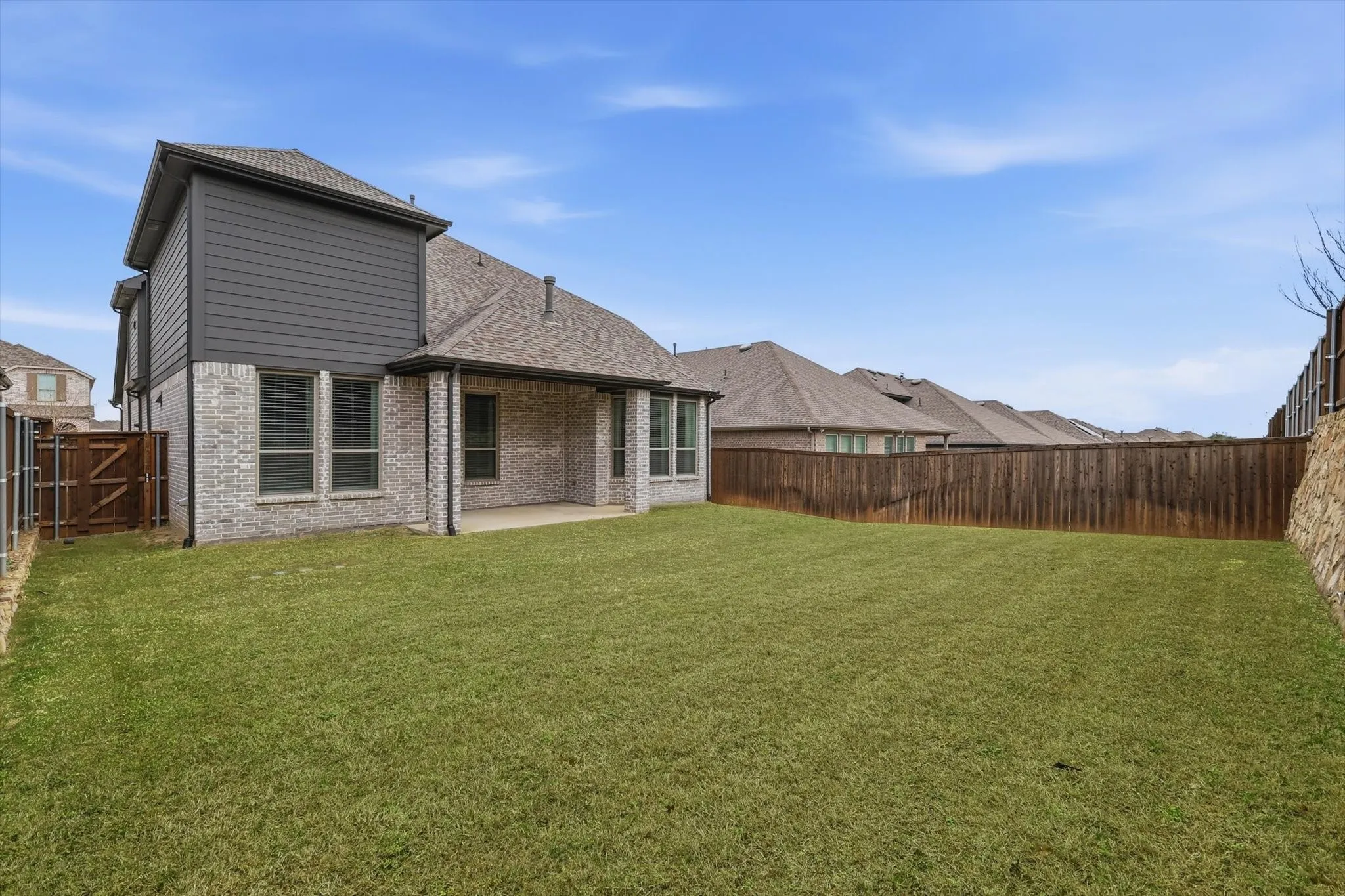 Back of home with large covered patio, EXTREMELY private with fencing and placement!