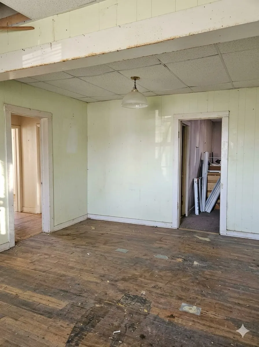 Room featuring dark wood-style flooring and a drop ceiling
