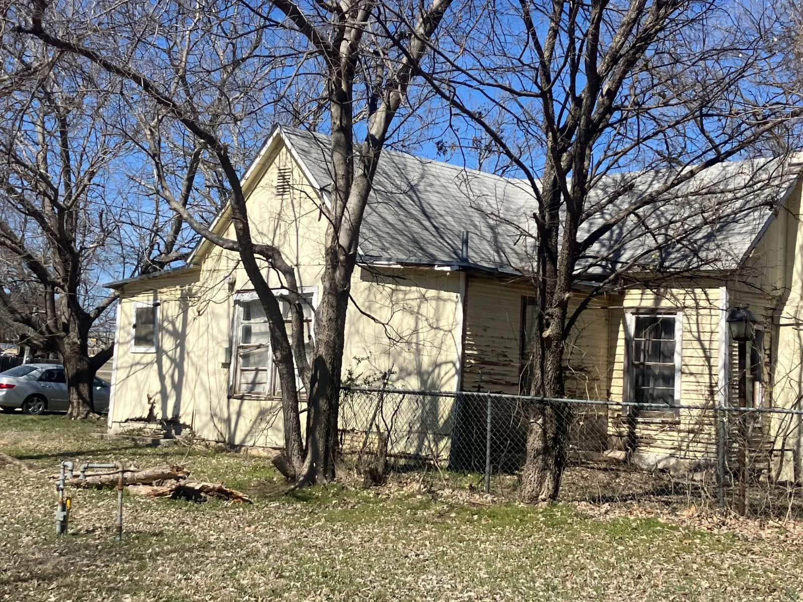 View of side of home with roof with shingles