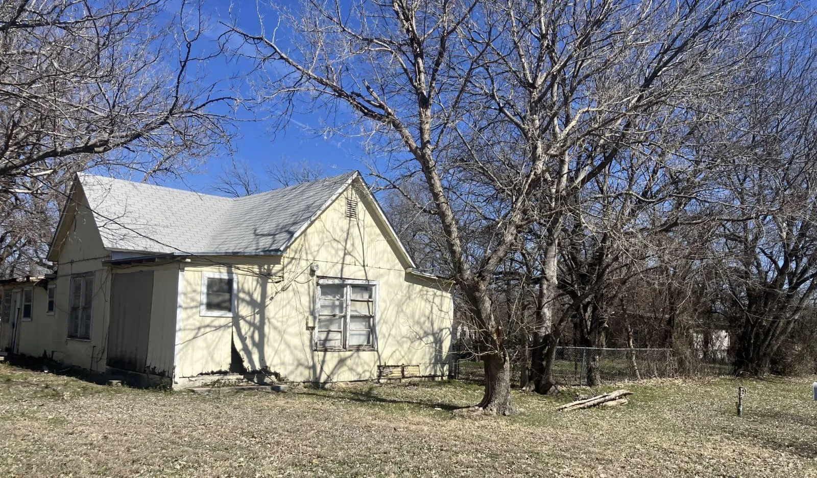 View of side of home featuring a shingled roof