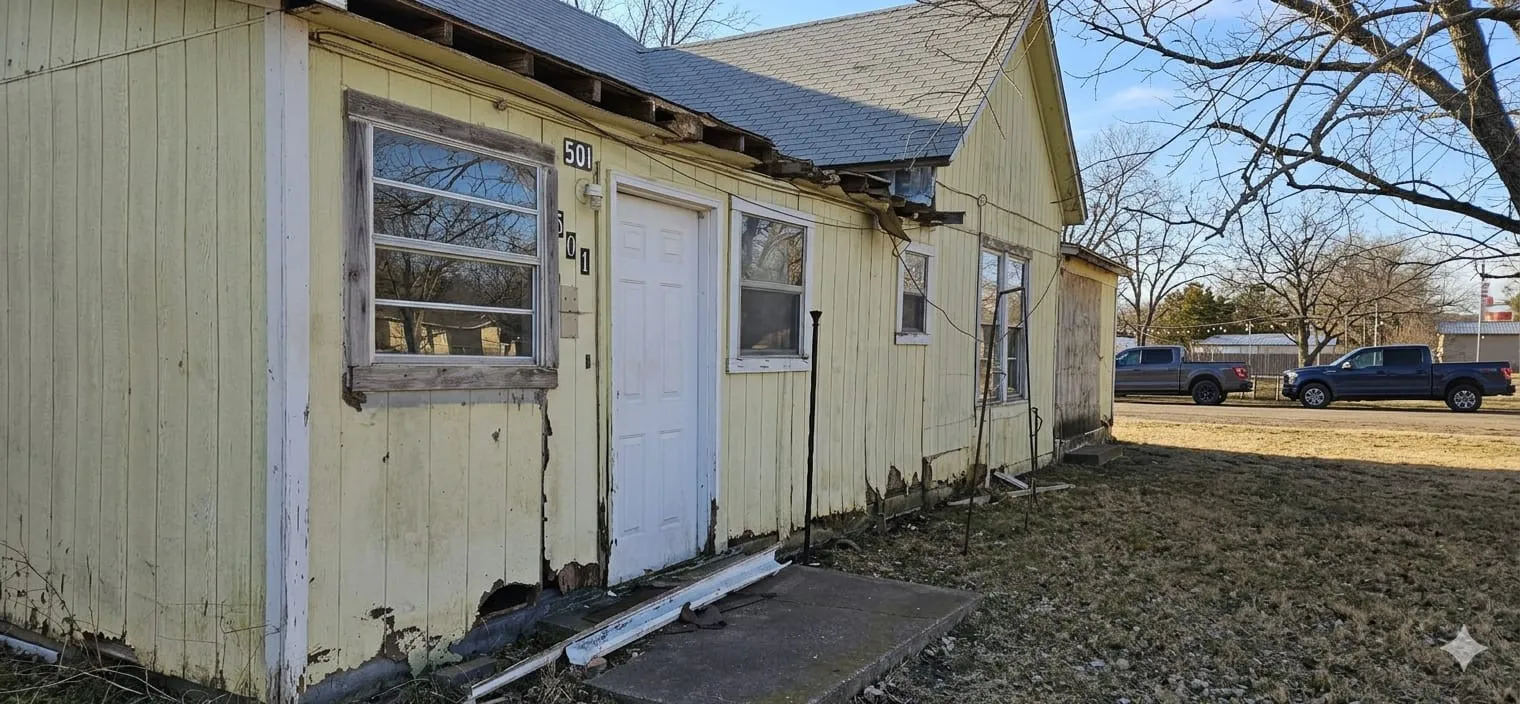 View of property exterior with roof with shingles