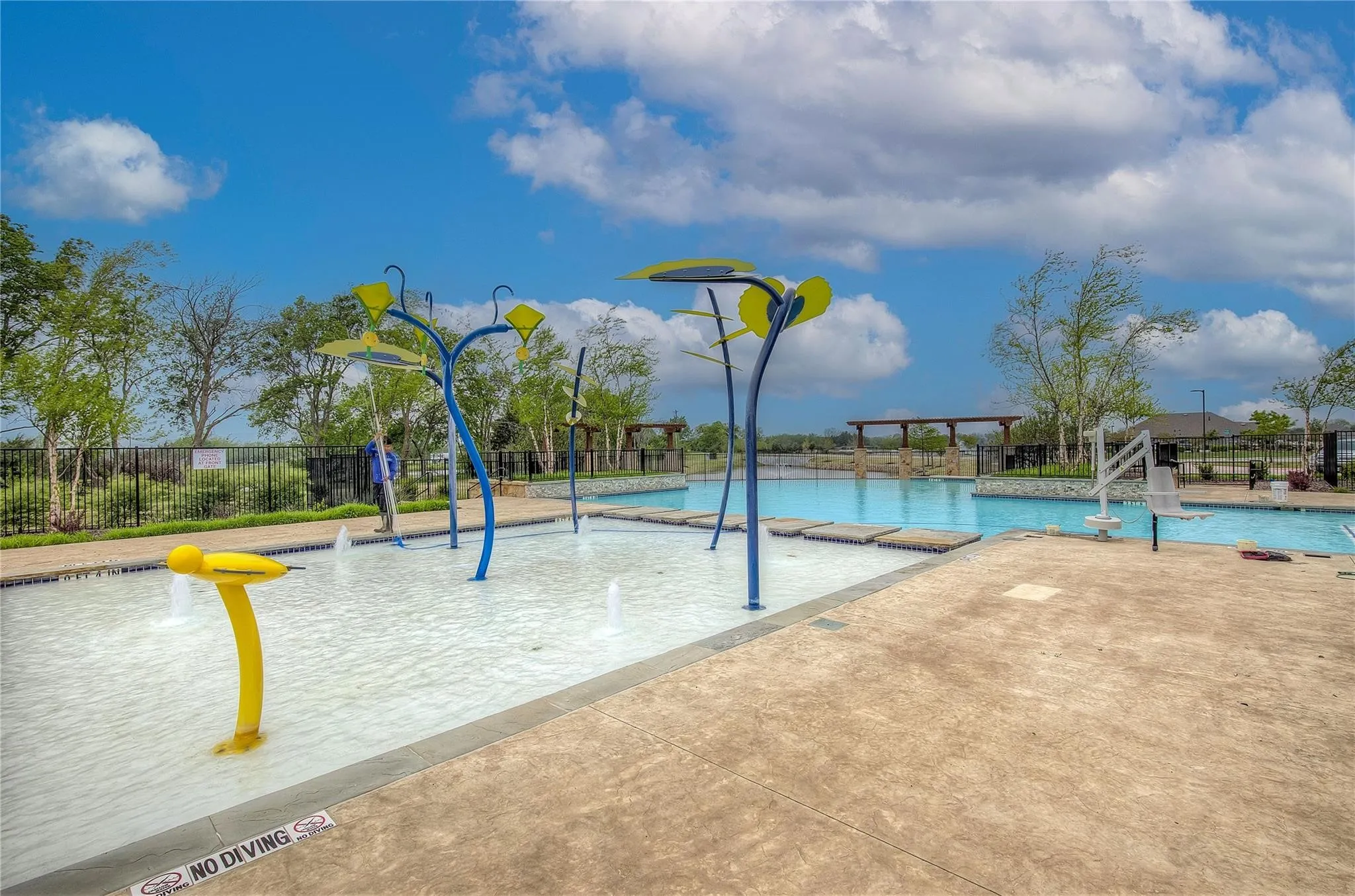Community pool featuring a water play area