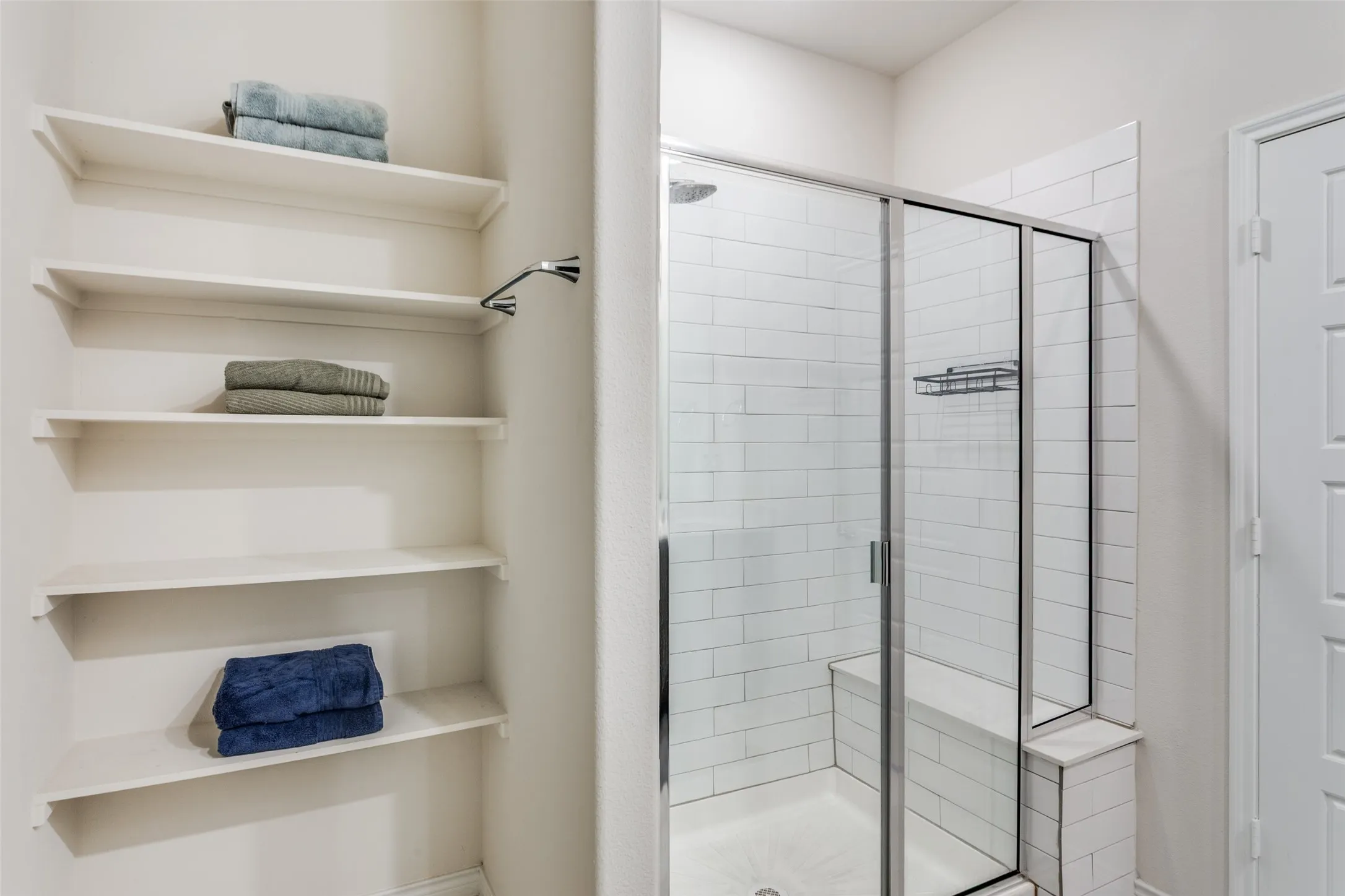 Full bathroom featuring a shower stall and a closet